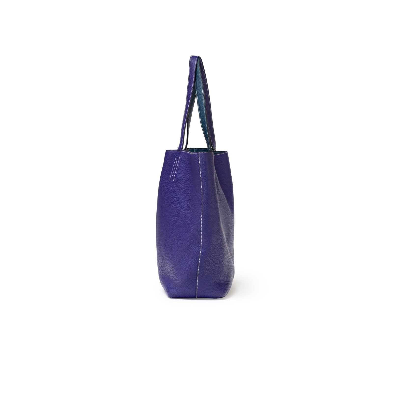 Side view of Hermès Double Sens Reversible Bicolor Shoulder Bag Clemence Violet/Blue showing purple leather texture