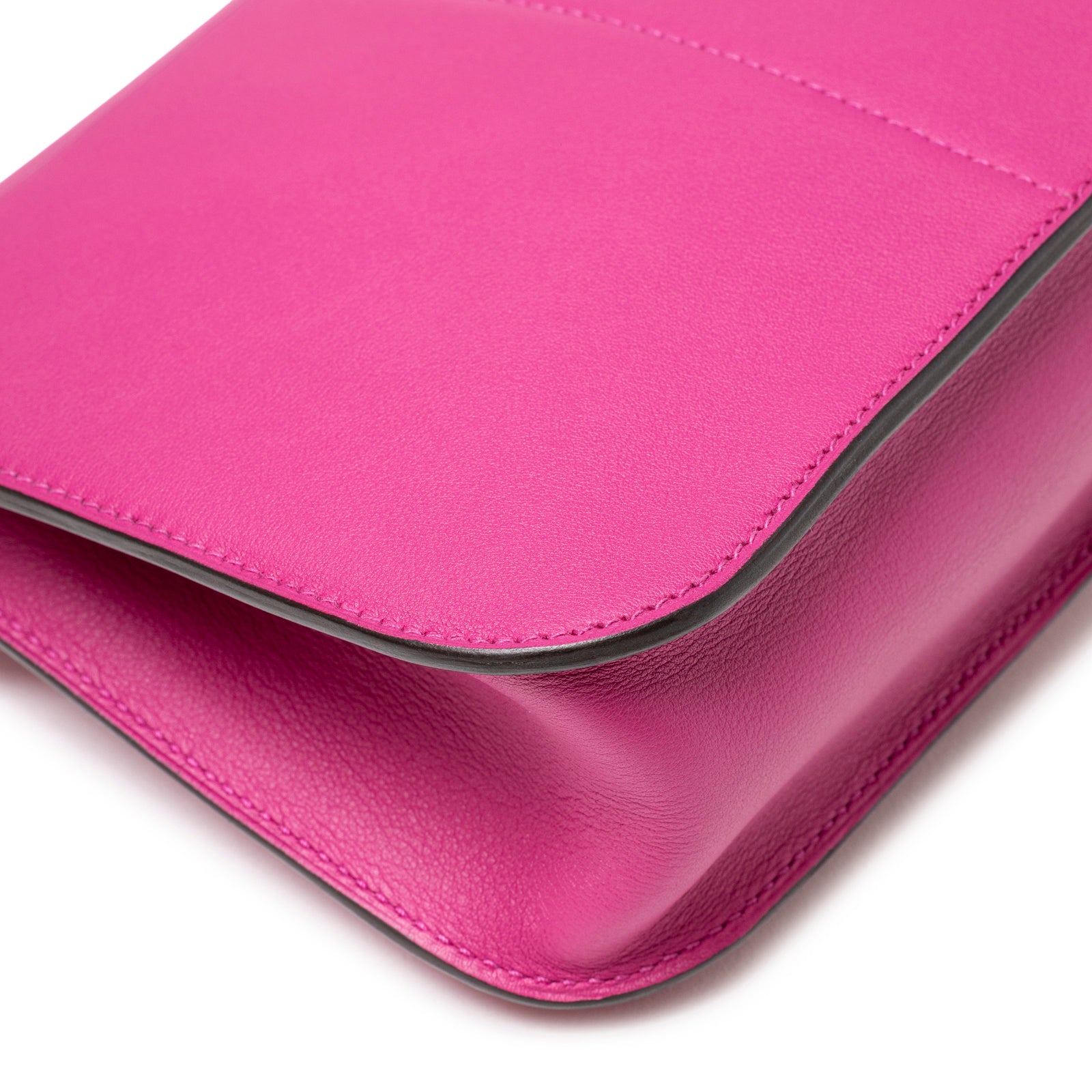 Close-up of bottom corner showing smooth leather texture and precise stitching on Hermès Halzan Mini Rose Pourpre Swift Palladium Hardware