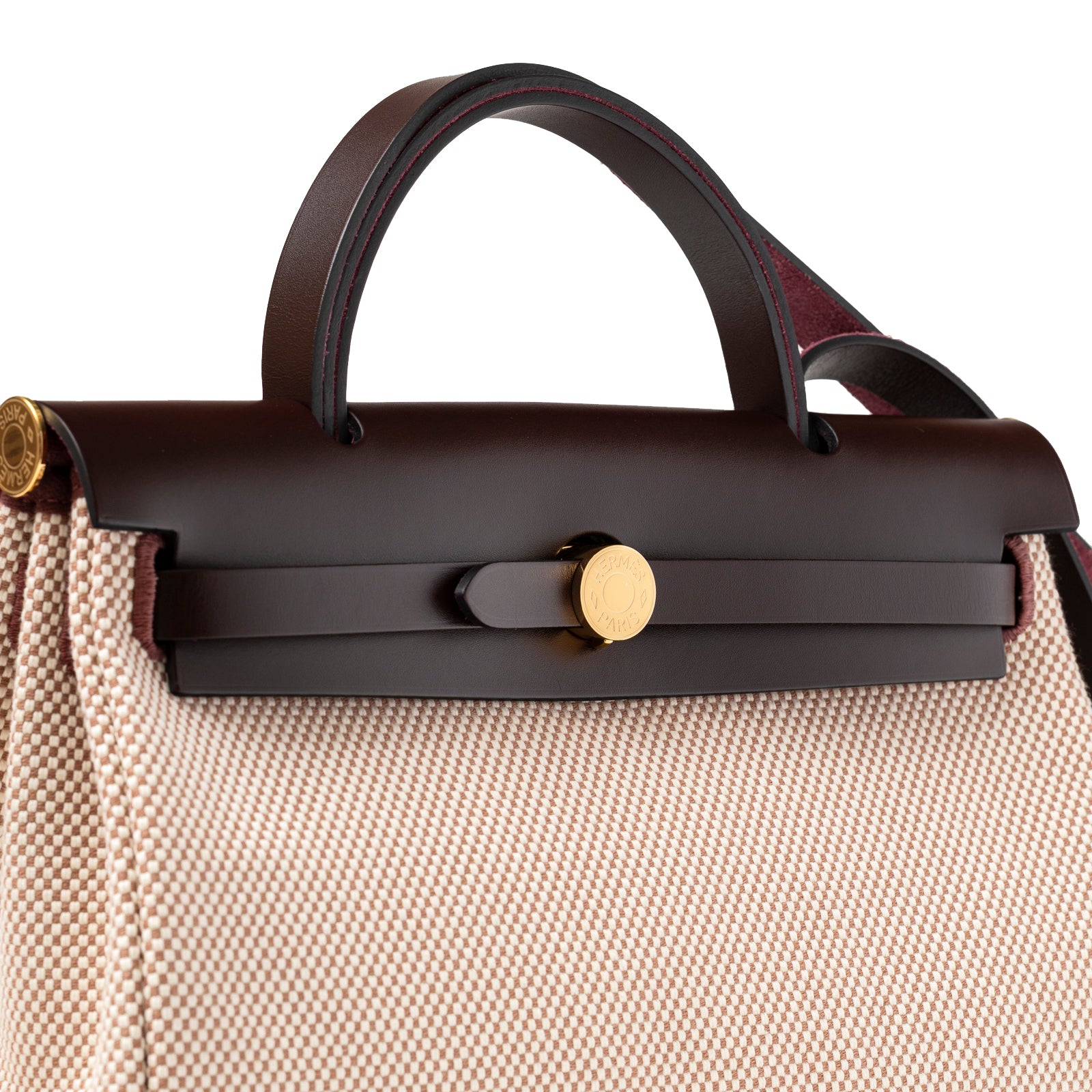 Close-up of top handle and flap showing dark leather and gold clasp on Hermès Herbag Zip PM 31 Ecru and Beige Toile H Ebene Hunter Gold Hardware