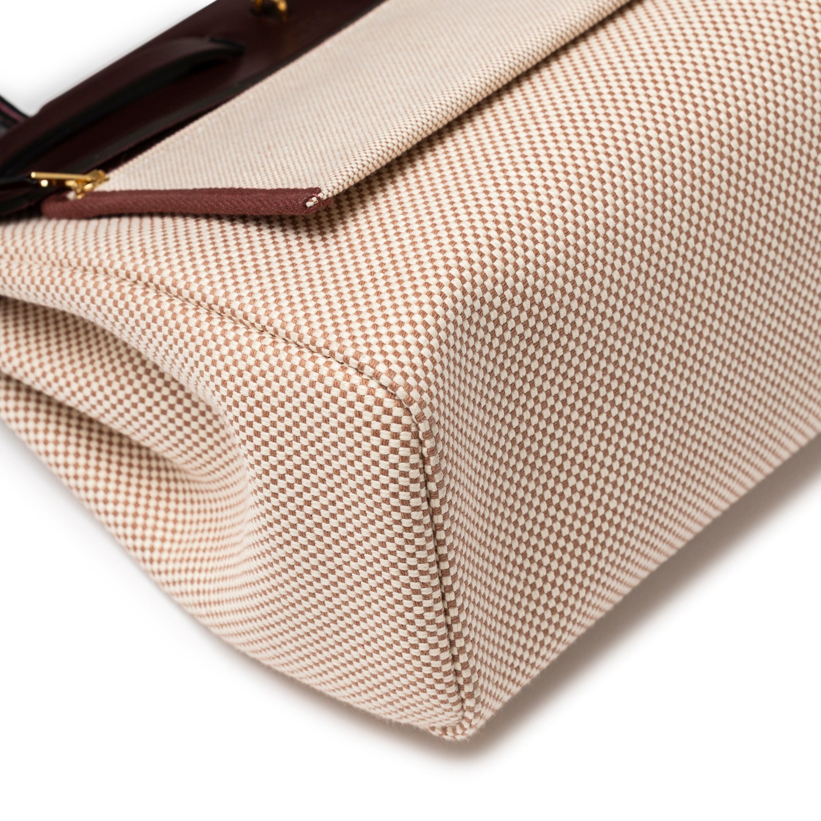 Close-up of corner detailing and textured beige canvas on Hermès Herbag Zip PM 31 Ecru and Beige Toile H Ebene Hunter Gold Hardware