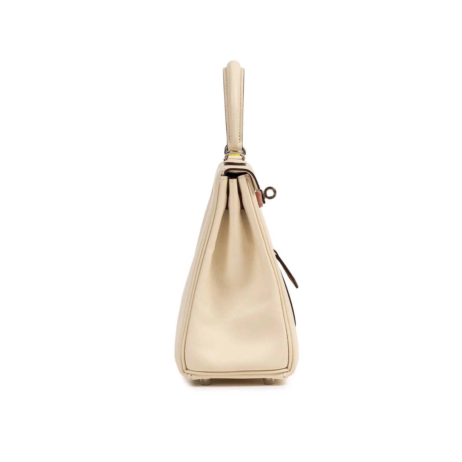 Side profile of Hermès Kelly 25 bag in nata swift leather showcasing its slim silhouette and handle detail