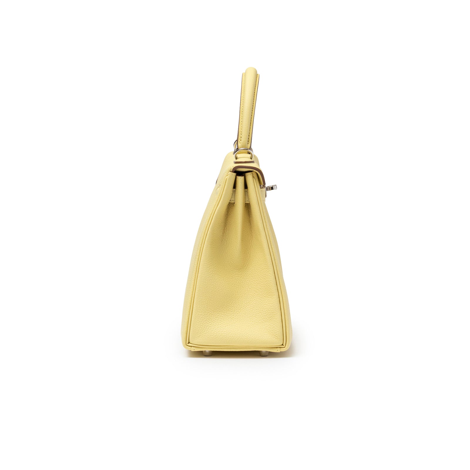Side view of Hermès Kelly 25 Retourne Togo Jaune Poussin Palladium Hardware showing smooth silhouette and leather texture