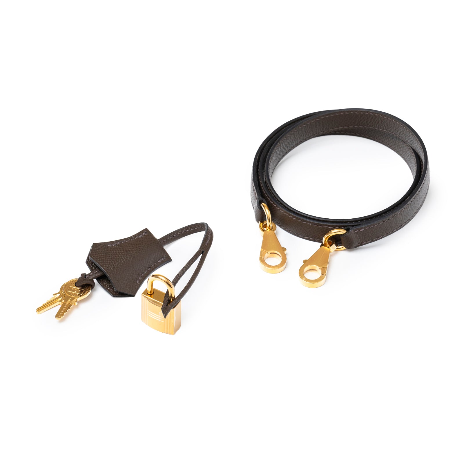 Close-up of gold lock, keys with leather clochette and black leather shoulder strap for Hermès Kelly 25 Sellier Ecore Epsom Gold Hardware