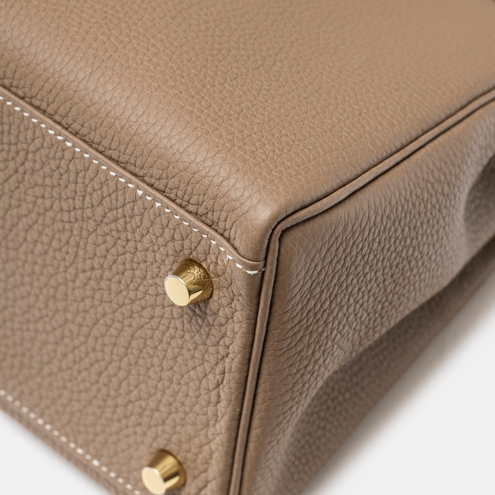 Close-up of Hermès Kelly 28 Retourne Etoupe Togo Gold Hardware bottom corner showing textured leather and gold studs