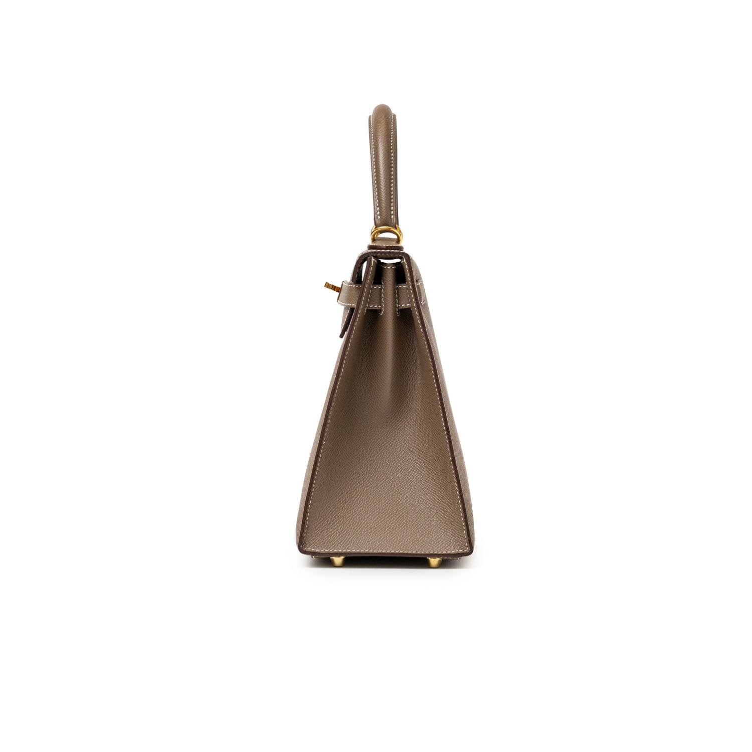 Side view of Hermès Kelly 28 Sellier Etoupe Epsom Gold hardware showcasing structured silhouette and handle details.