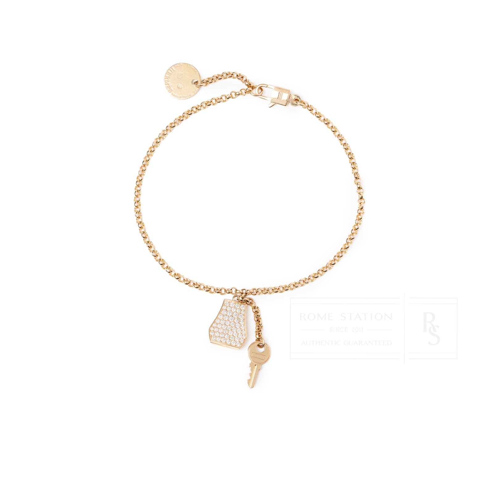 Top-down view of Hermès Kelly Clochette Bracelet 18K Rose Gold Diamonds with key and charm details
