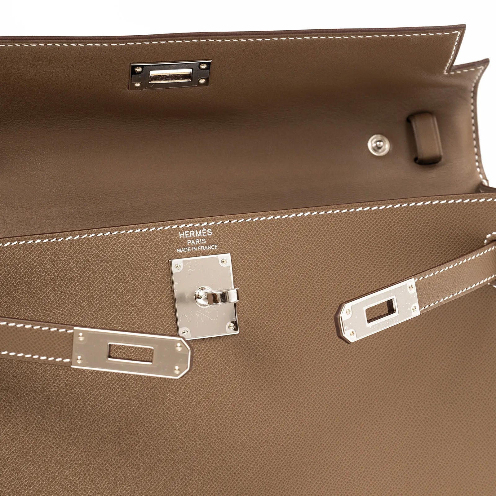 Close-up interior view of Hermès Kelly Elan Etoupe Madame Palladium Hardware showing stitching and clasp details