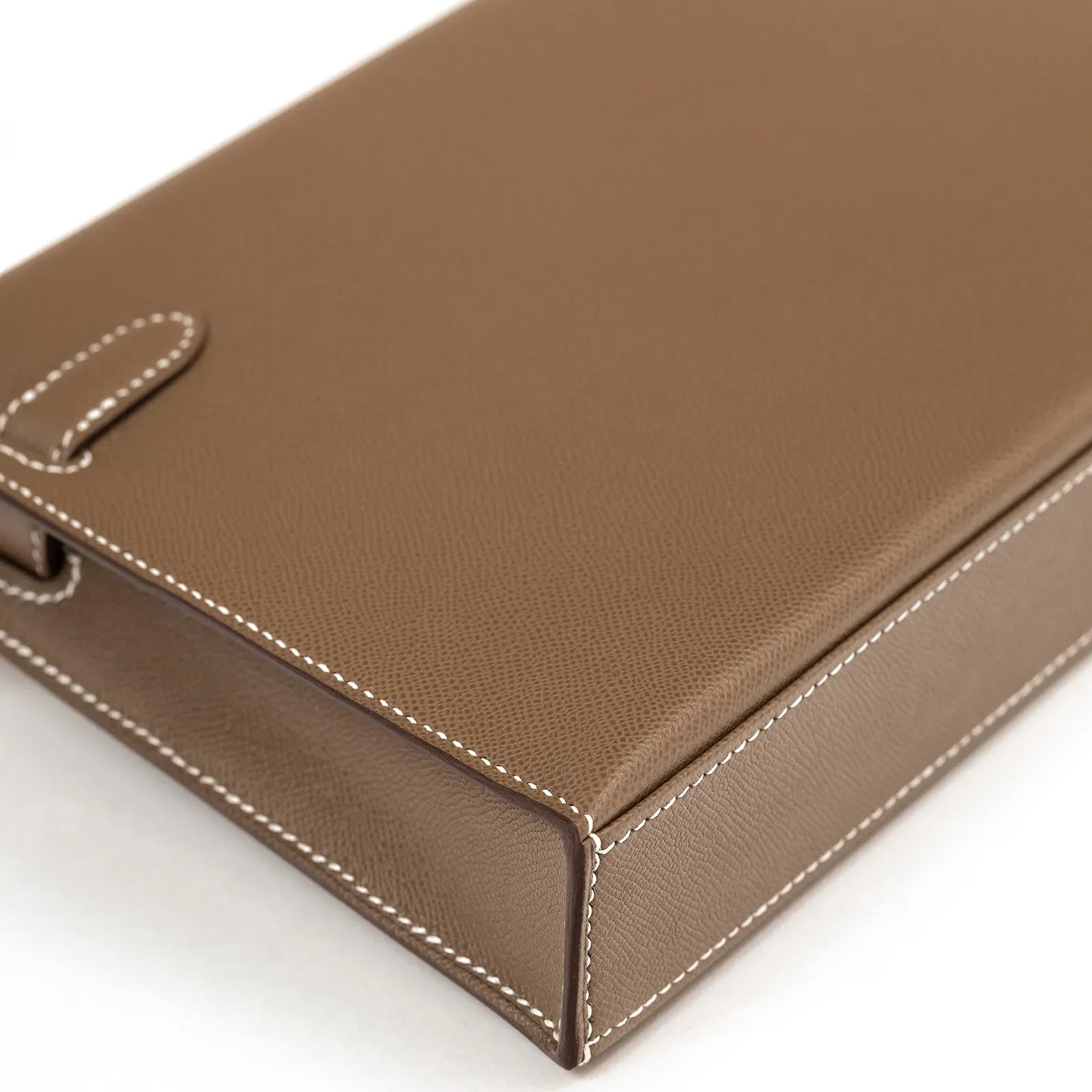 Close-up angled view of Hermès Kelly Elan Etoupe Madame Palladium Hardware showing Etoupe leather texture and white stitching detail