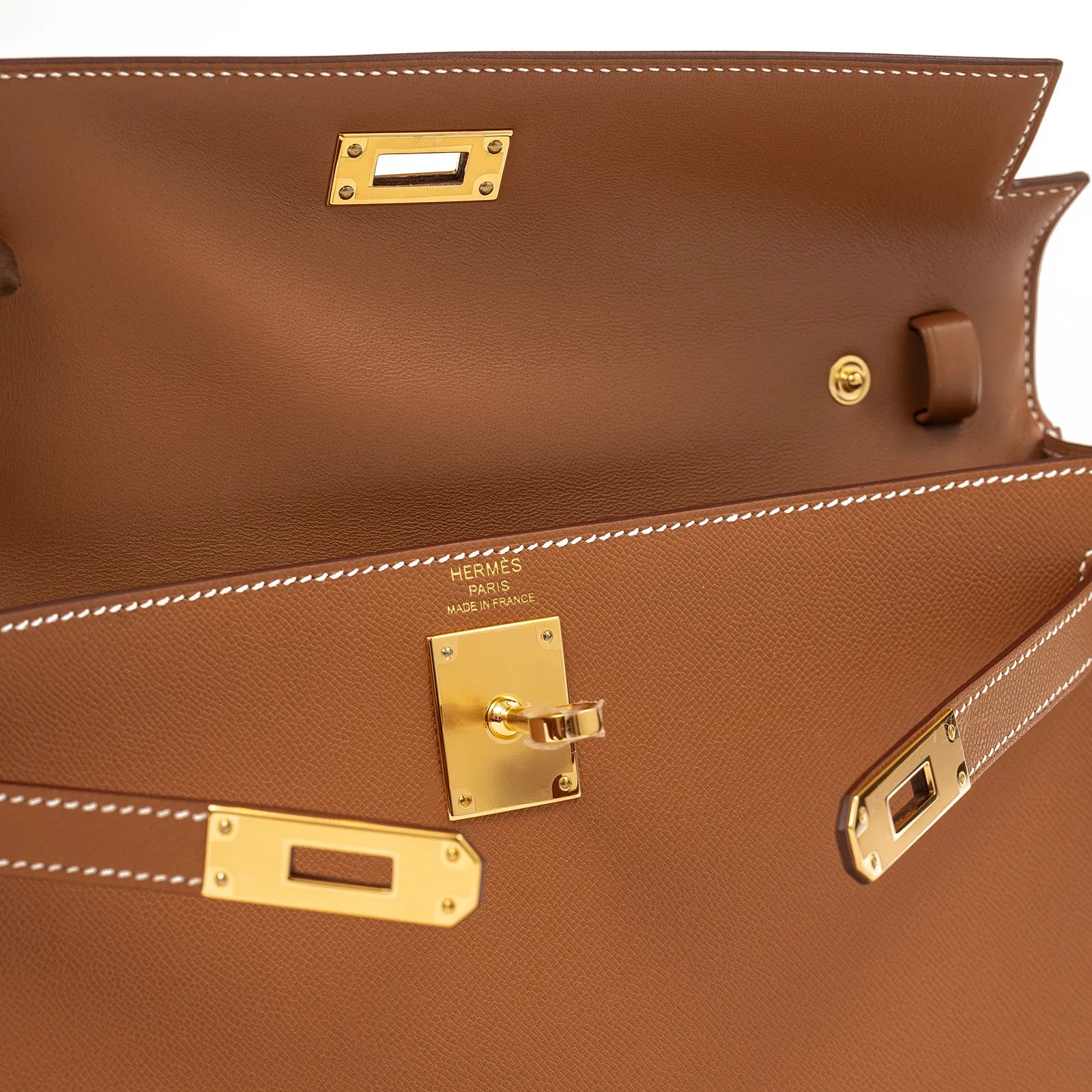 Close-up interior view of Hermès Kelly Elan Gold Madame Gold Hardware showcasing stitching and gold clasp details