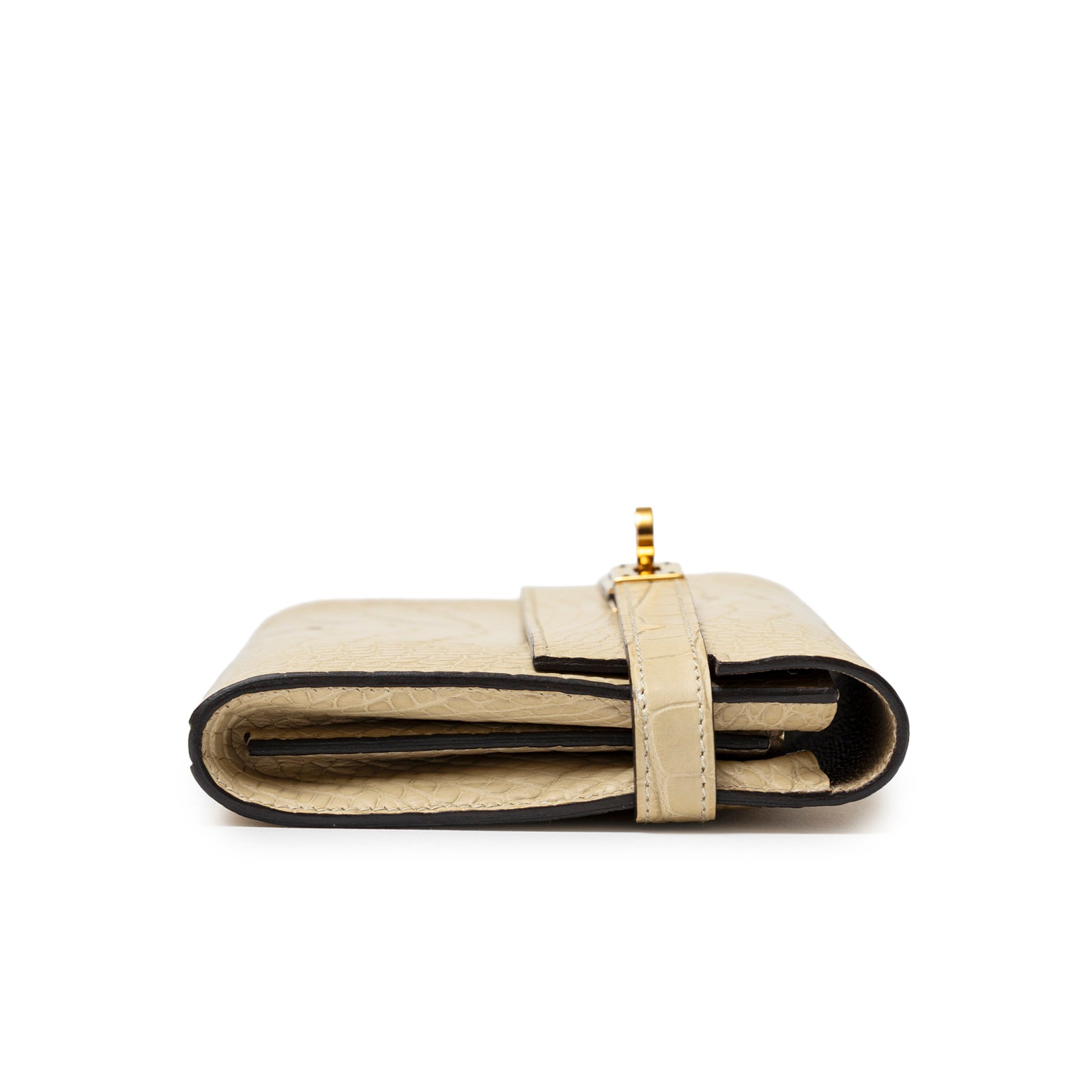 Side profile of Hermès Kelly Long Wallet Vanille Matte Alligator Gold Hardware showing folded edges and strap closure