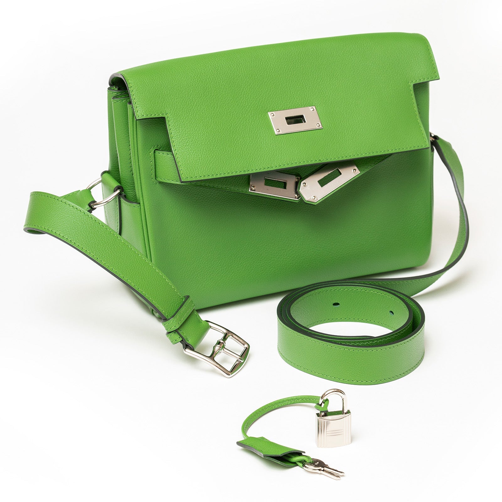 Hermès Kelly Messenger PM Vert Yucca Evercolor Palladium Hardware handbag with silver clasp, detachable strap, and matching belt on white background.