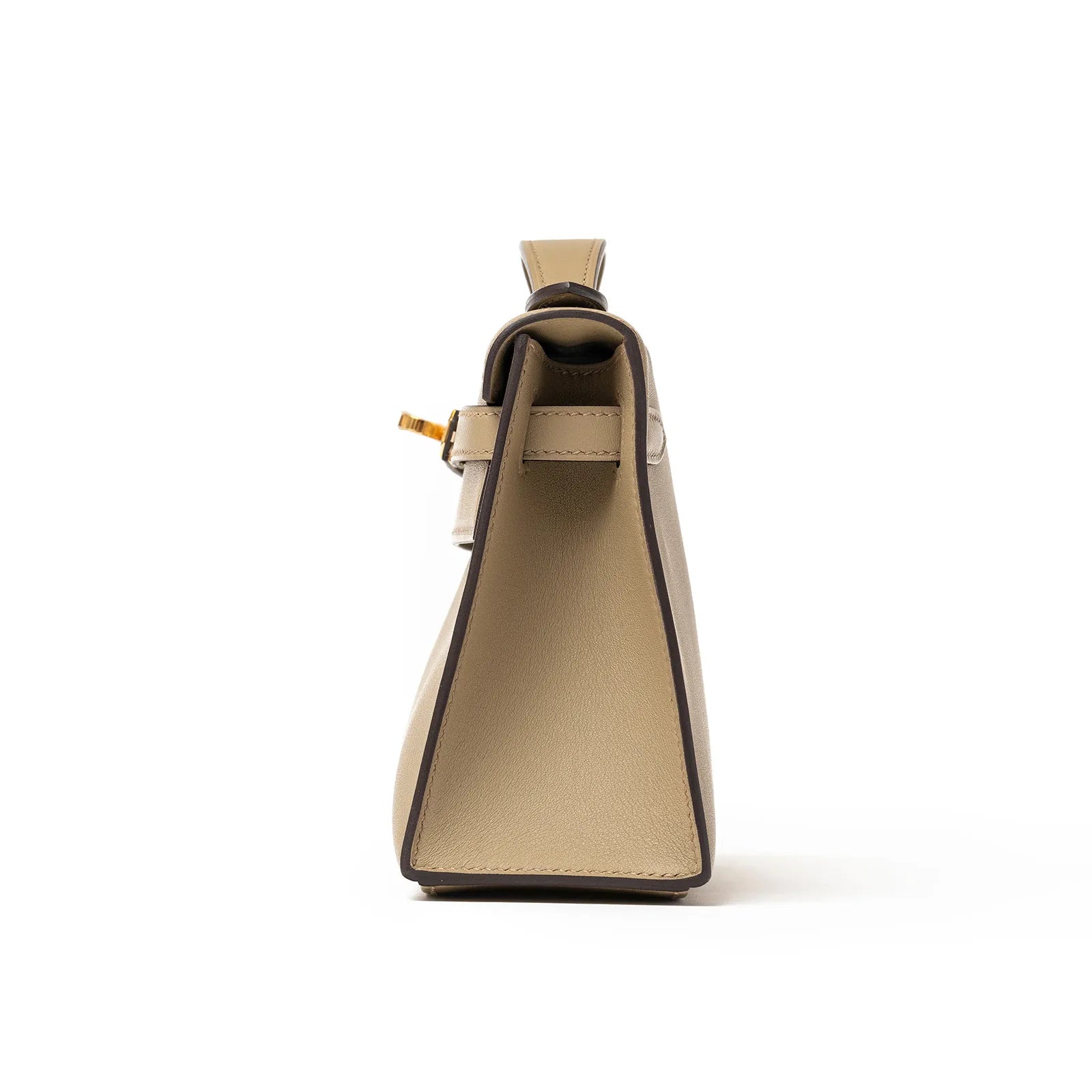 Side view of the Hermès Kelly Pochette Beige Marfa Swift Gold Hardware showcasing its structured silhouette and craftsmanship