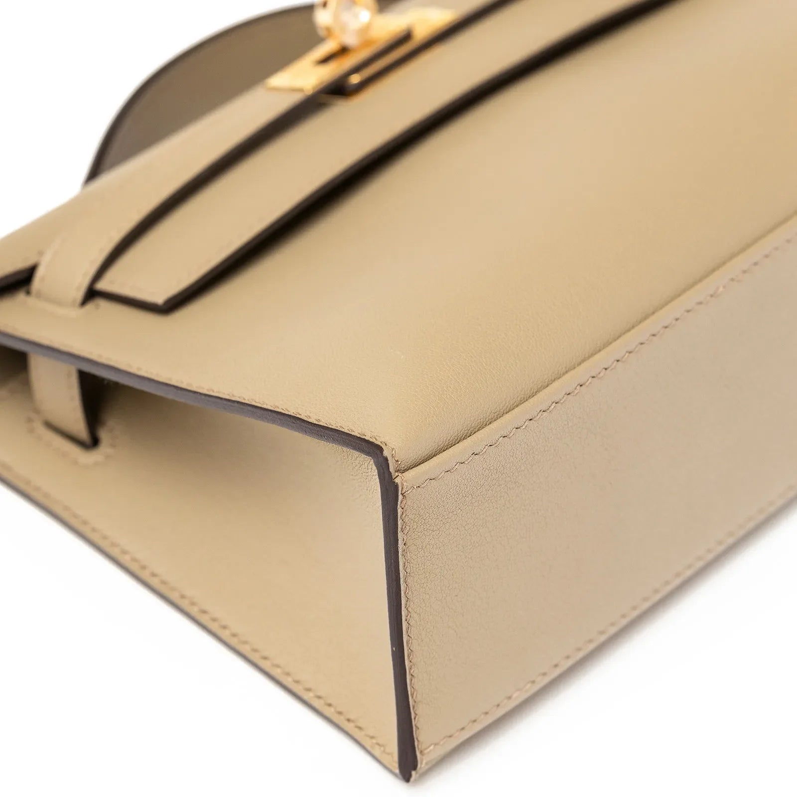 Close-up view of the Hermès Kelly Pochette Beige Marfa Swift Gold Hardware showcasing fine leather craftsmanship and elegant design details