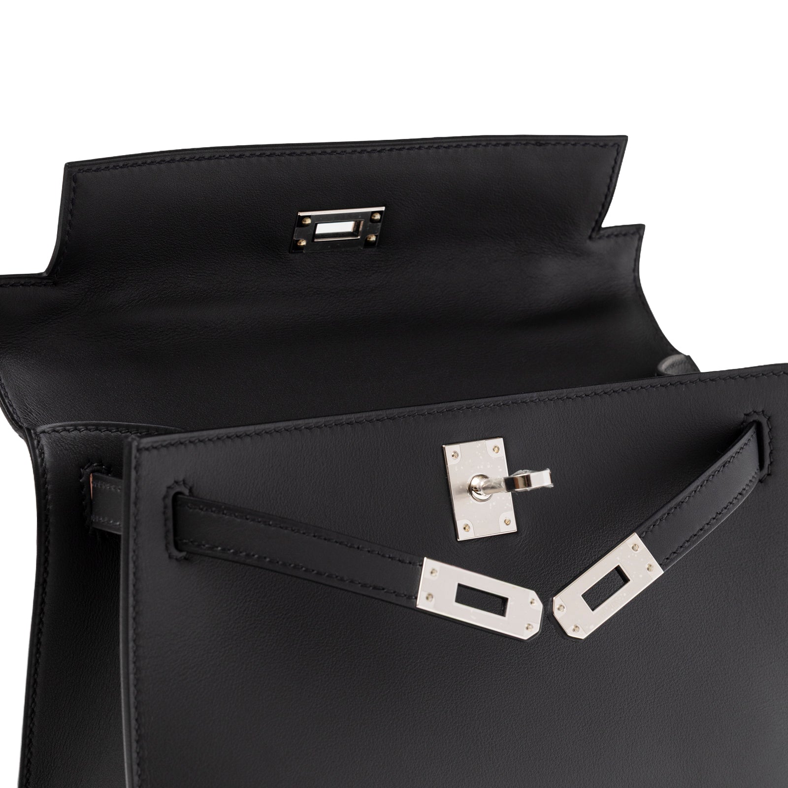 Open interior view of Hermès Kelly Pochette Black Swift Palladium Hardware showing smooth leather and clasp detail