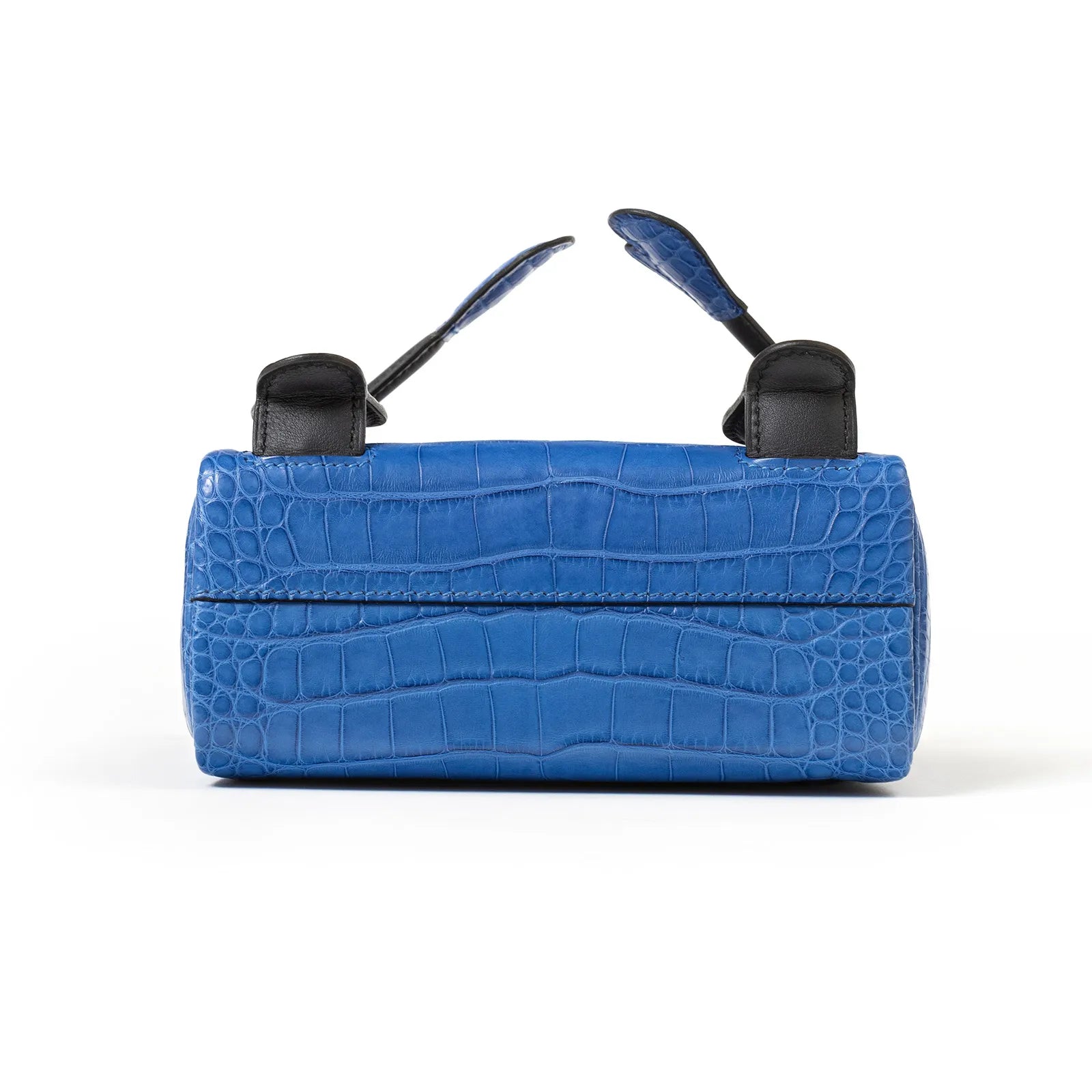 Bottom view of Hermès Kelly Quelle Idole Doll Bag AB Bleu Zellige/Bleu Indigo Palladium Hardware showing crocodile texture and handle ends