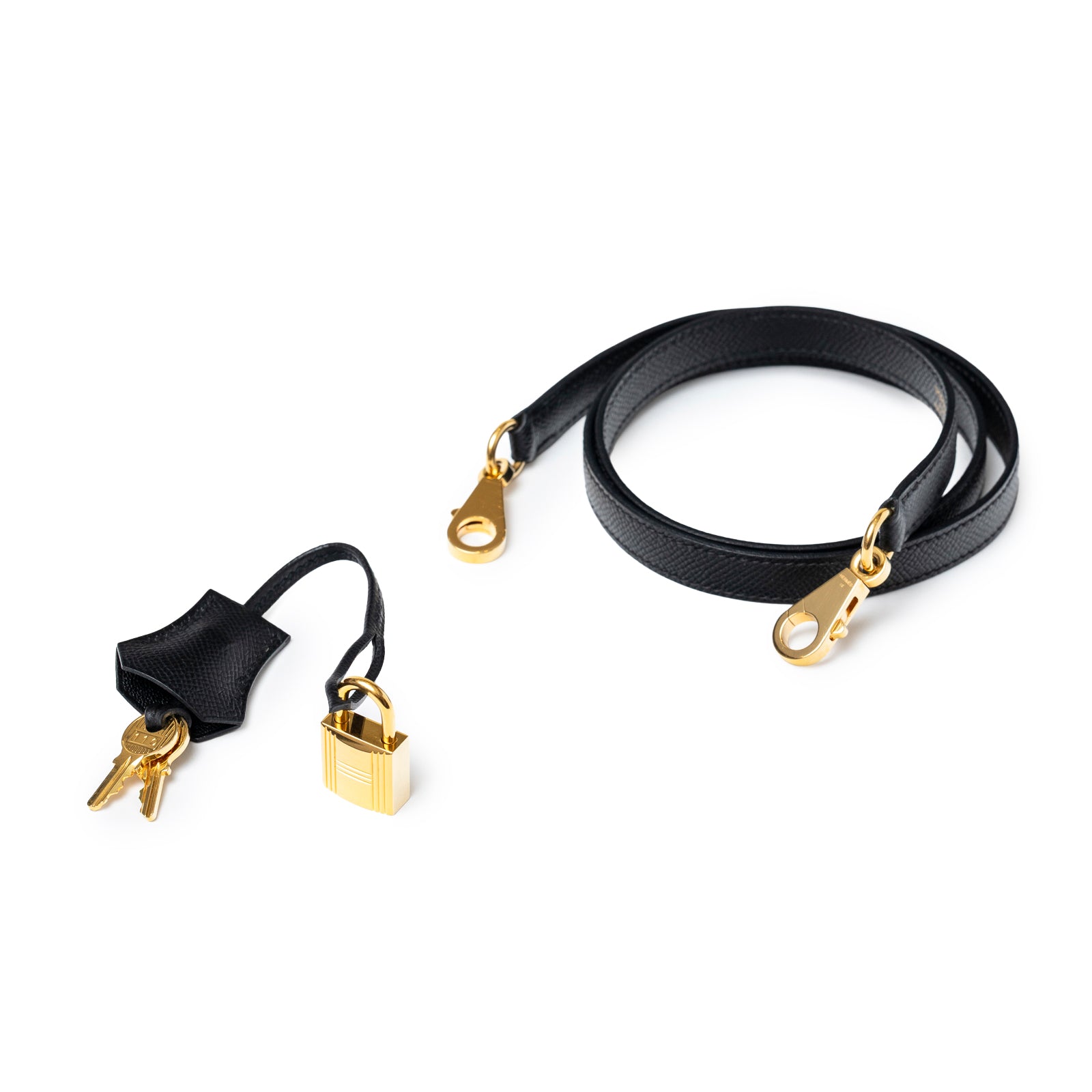 Detailed view of Hermès Kelly Sellier 25 Black Epsom Gold Hardware strap with lock and keys accessories