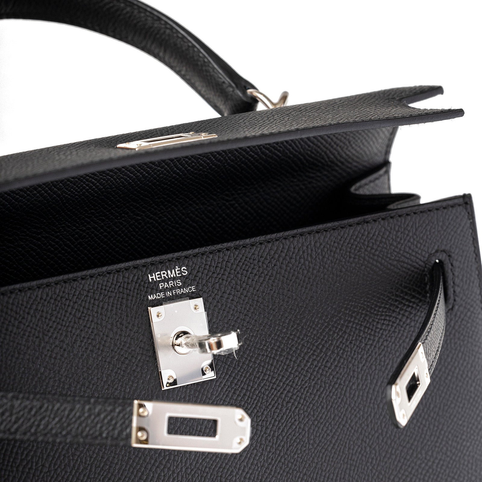 Close-up of open Hermès Kelly 25 Sellier Black Epsom Palladium Hardware showing interior and clasp details
