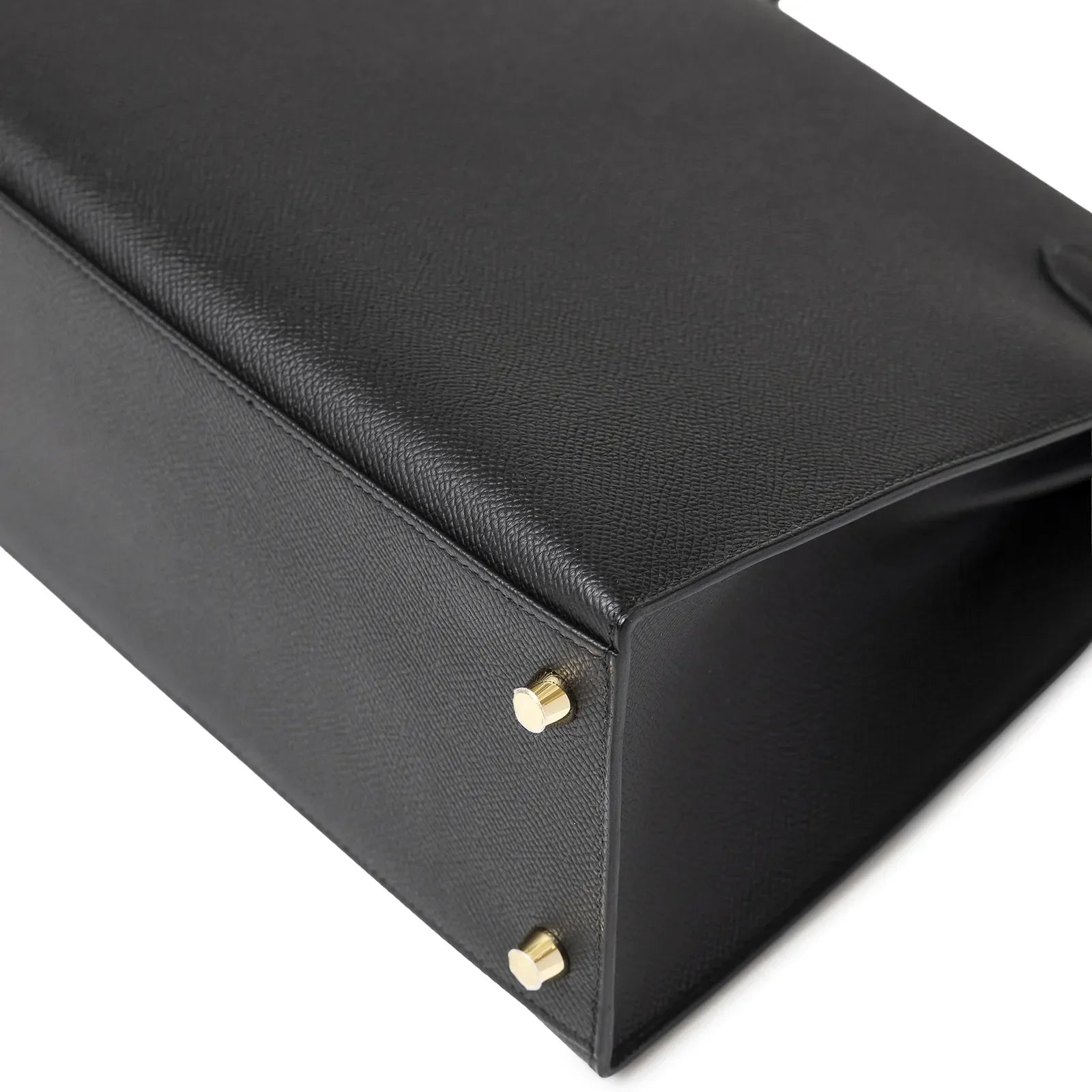 Close-up bottom view of Hermès Kelly 28 Sellier Black Epsom Gold Hardware showing textured leather and gold feet