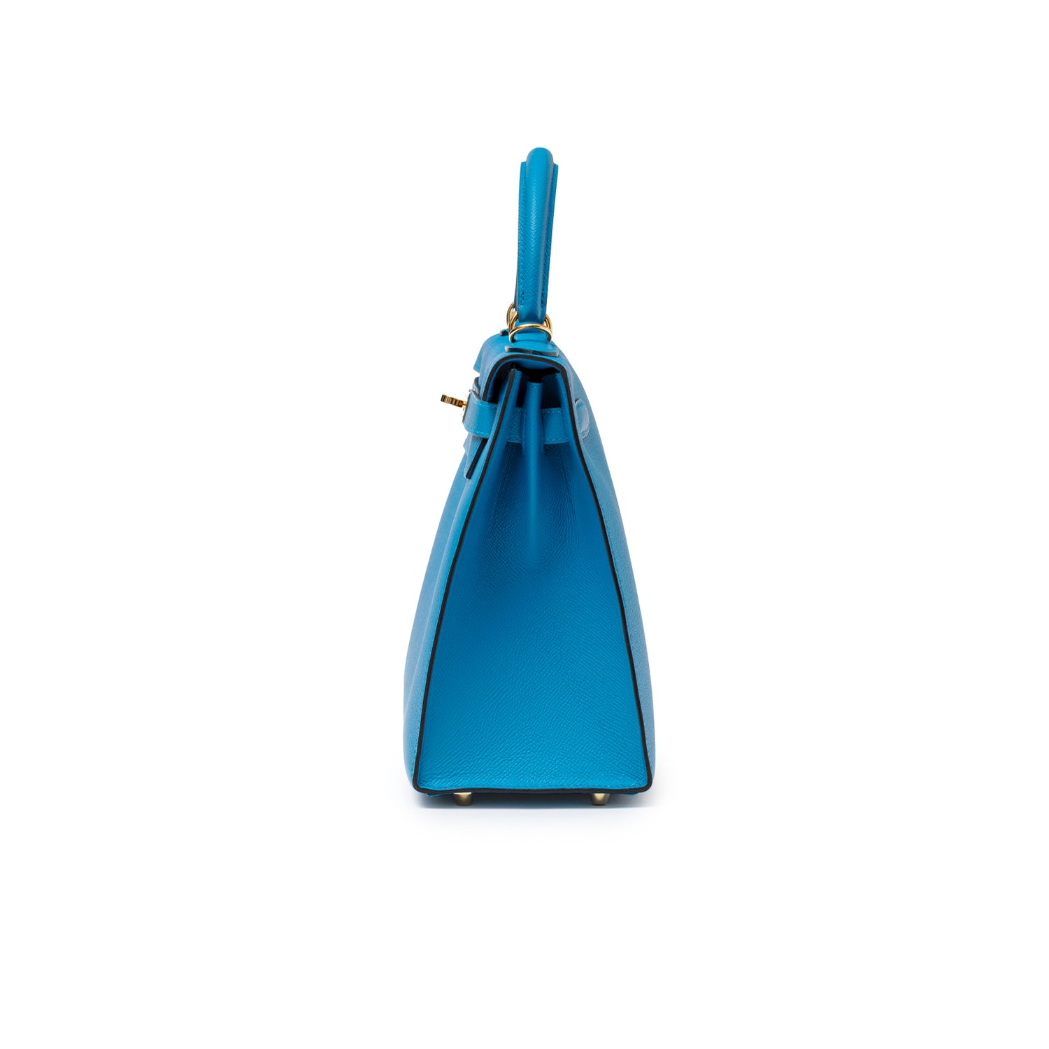 Side profile of Hermès Kelly Sellier 28 Blue Zanzibar Epsom Gold Hardware handbag showing handle and base studs.