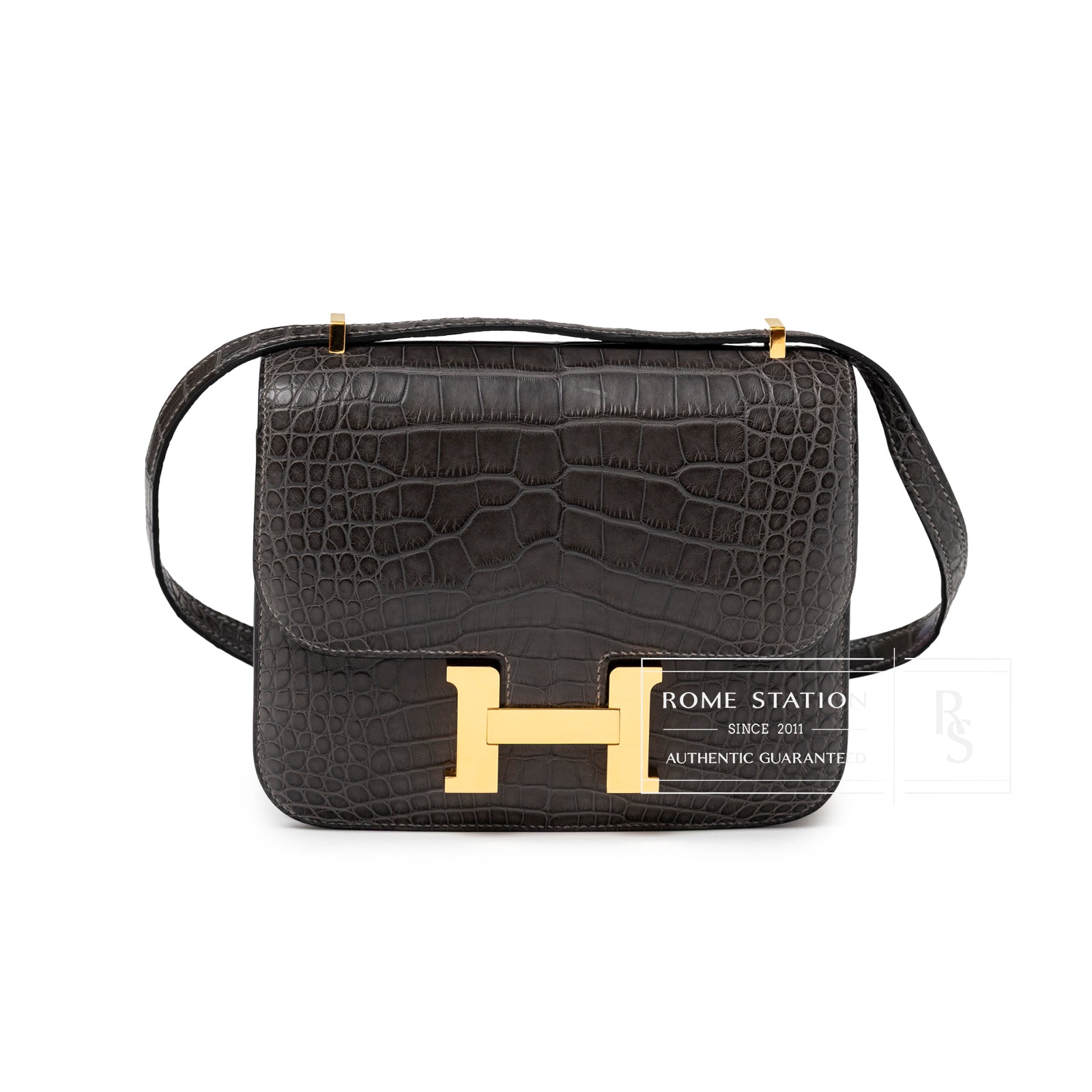 Front view of Hermès Mini Constance 18 Graphite Matte Alligator Gold Hardware with signature H clasp and textured leather