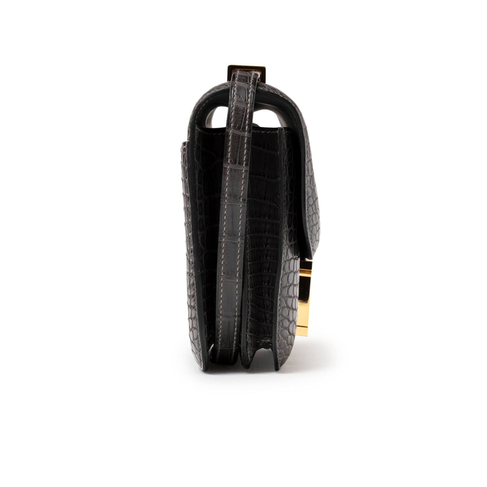 Side view of Hermès Mini Constance 18 Graphite Matte Alligator Gold Hardware showing structured silhouette and textured leather