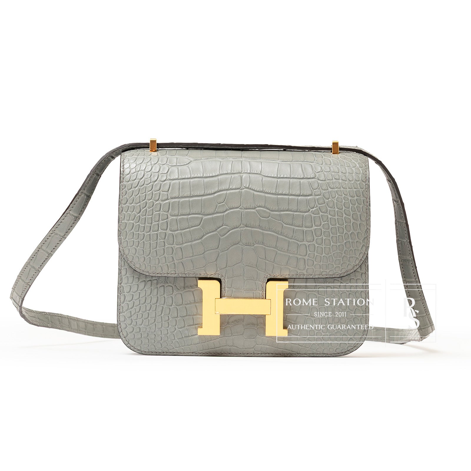Front view of Hermès Mini Constance 18 Gris Ciment Matte Alligator Gold Hardware with textured leather strap