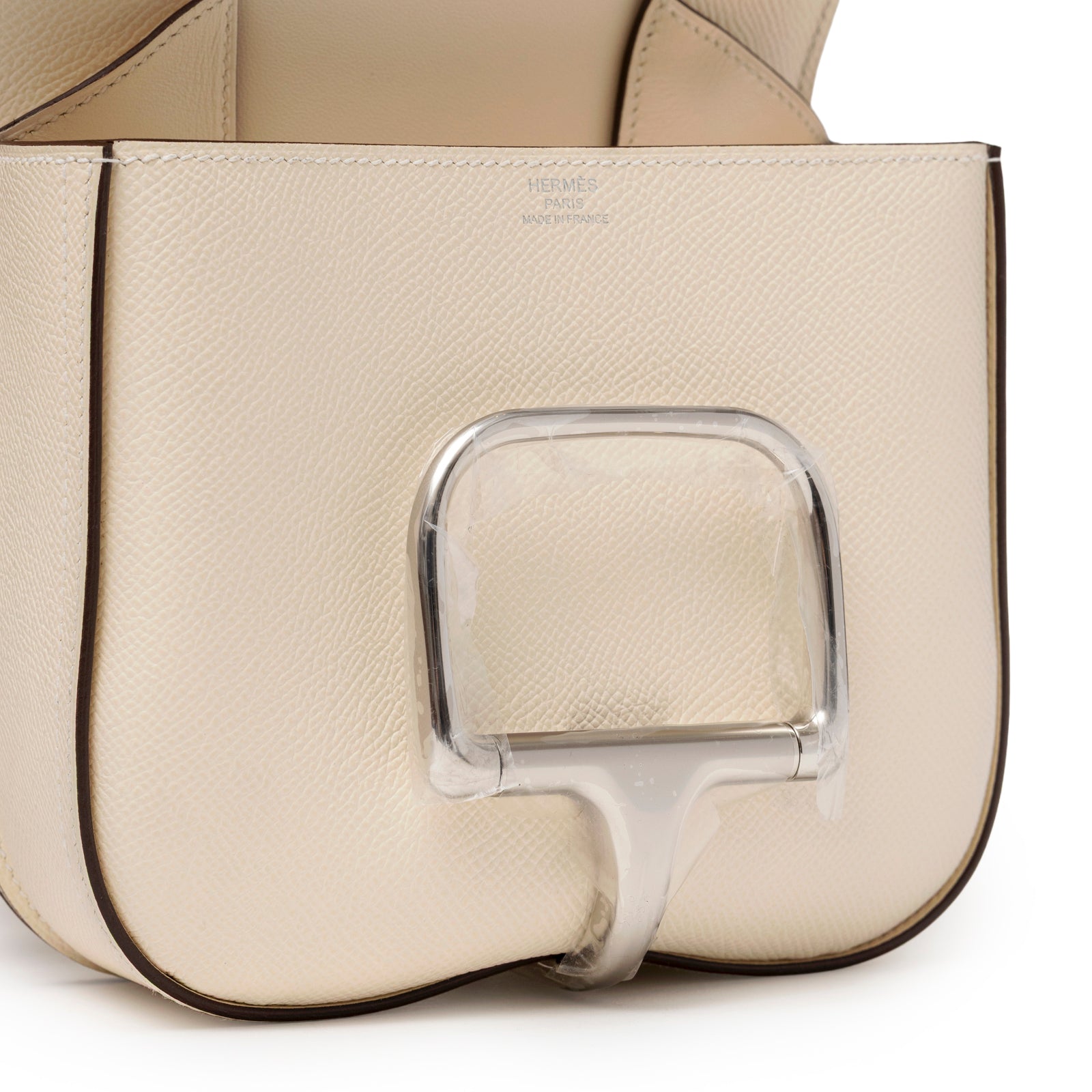 Close-up angled shot of Hermès Mini Della Cavalleria Craie Epsom Palladium Hardware showing front flap and textured cream leather