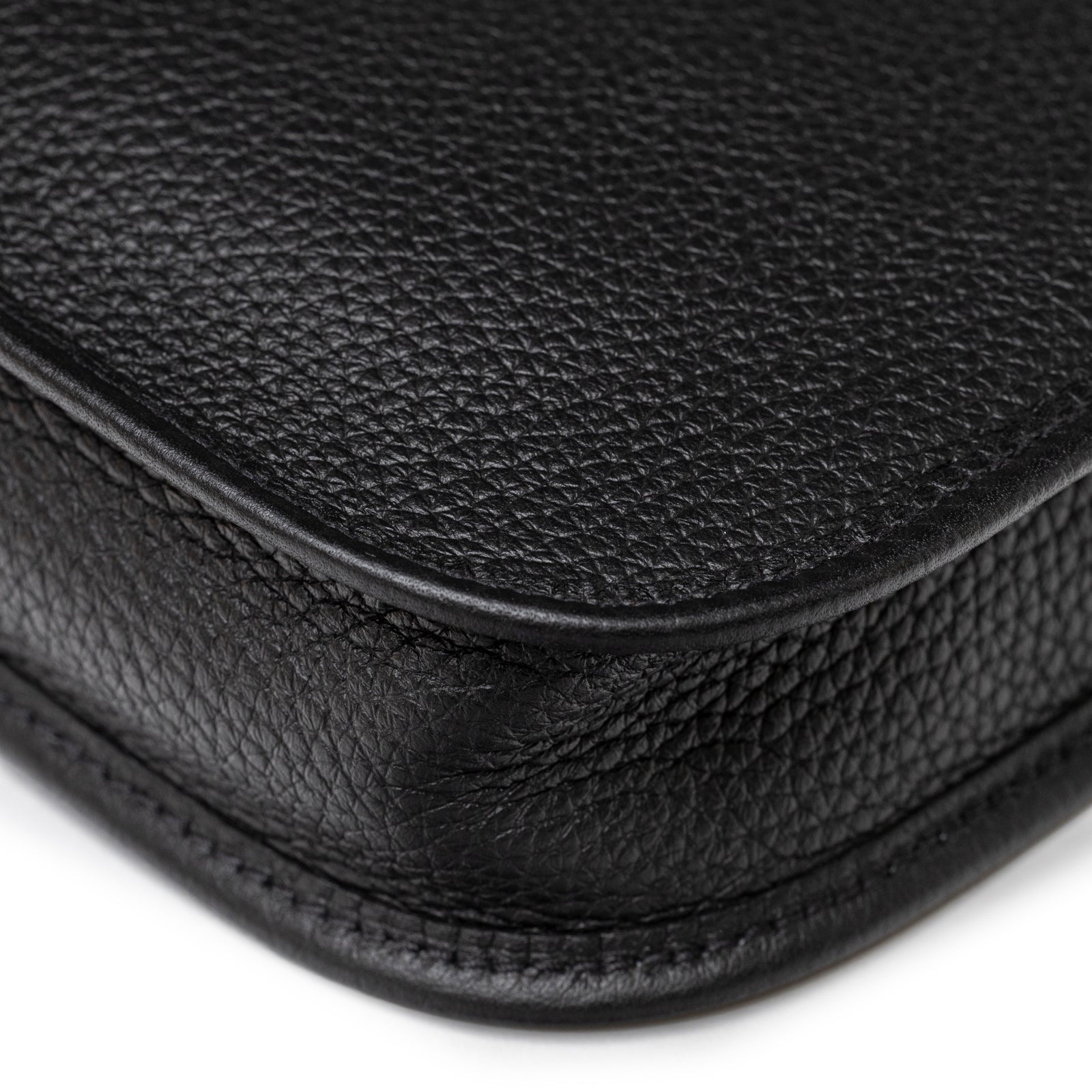 Close-up of Hermès Mini Evelyne Black Clemence Palladium Hardware textured leather corner with fine stitch detail