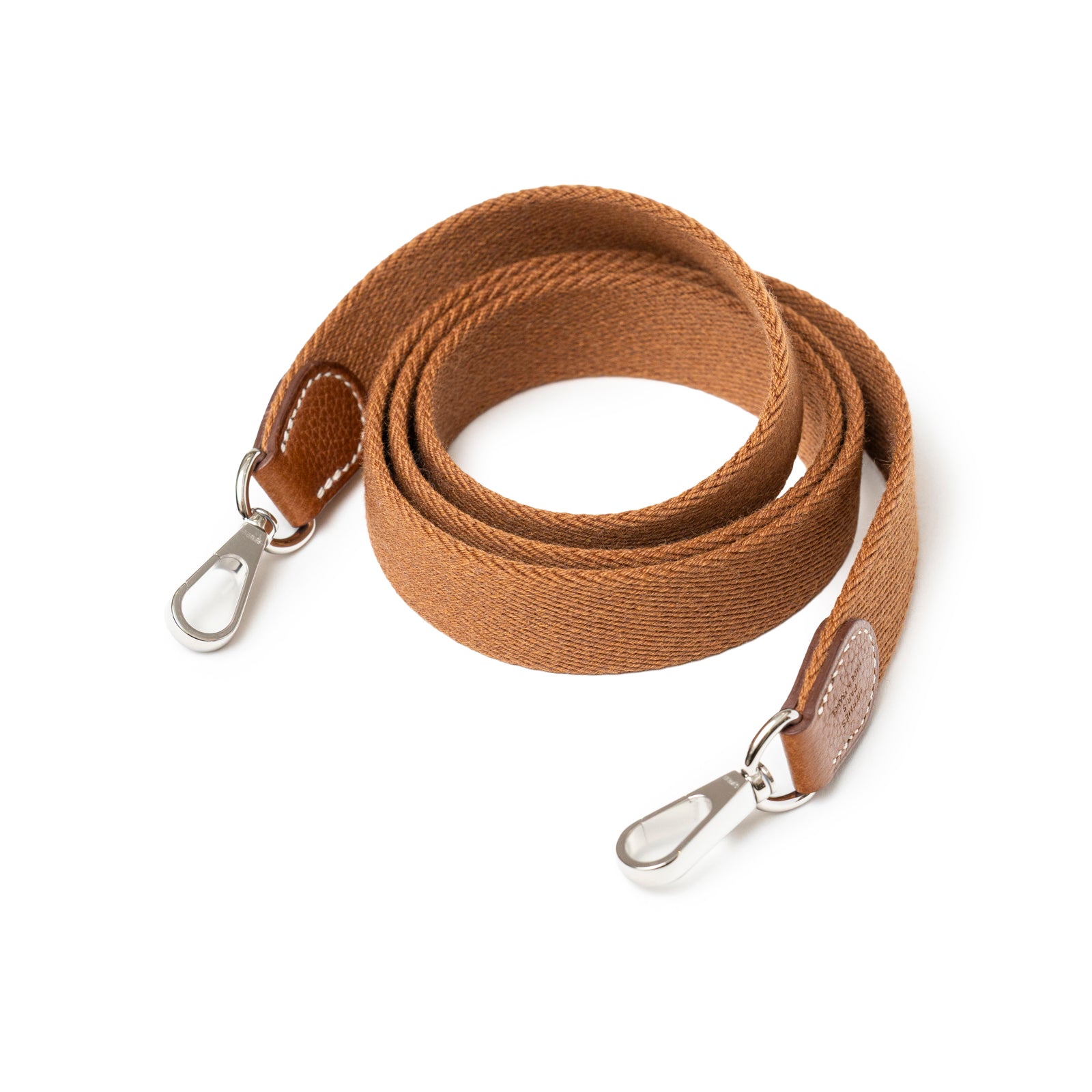 Hermès Mini Evelyne Fauve Barenia Palladium Hardware strap in cognac leather with silver clasps close-up view