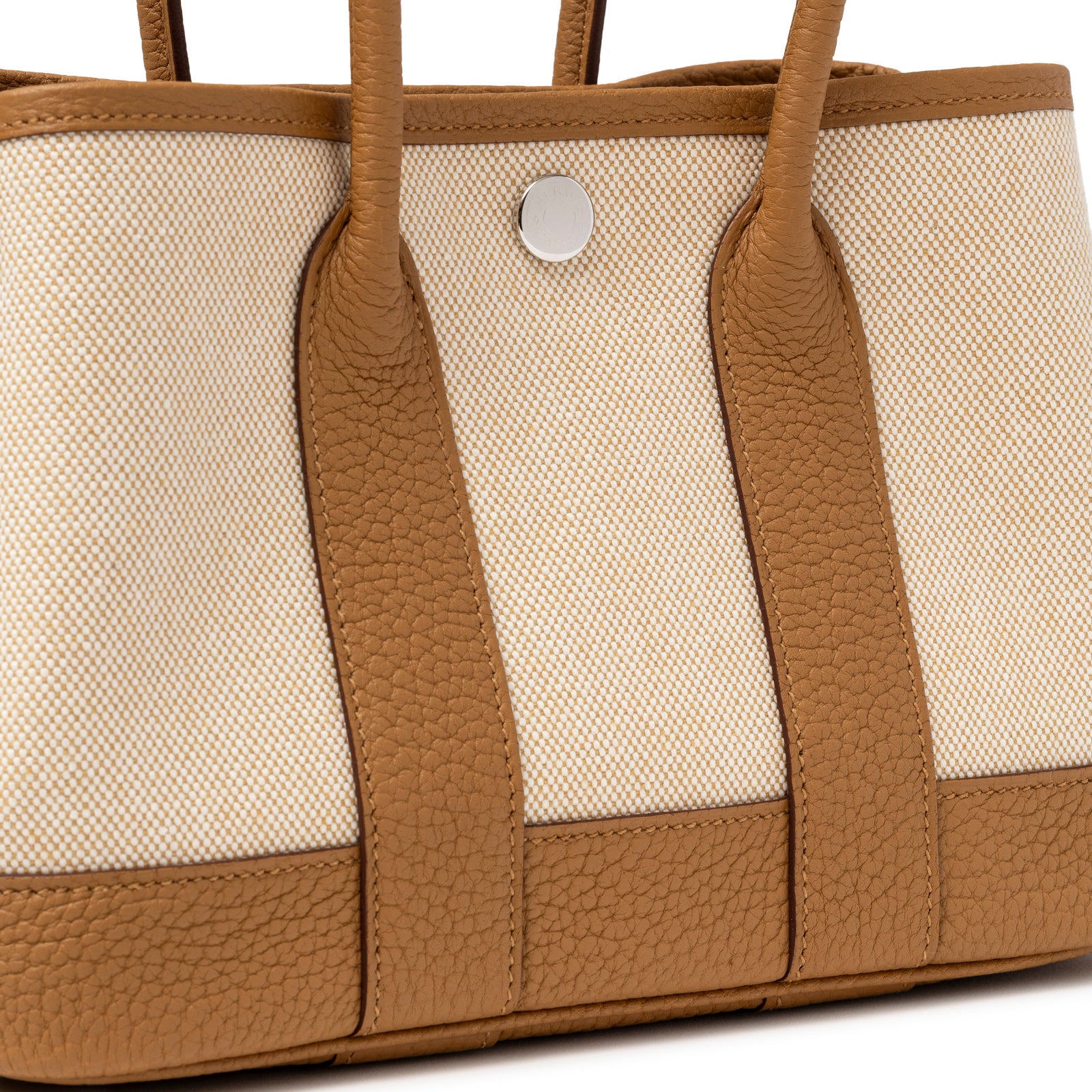 Close-up of textured Sesame Negonda leather trim and canvas detail on Hermès Mini Garden Party Neo 23 Ecru-Paille Toile H Canvas and Sesame Negonda Palladium Hardware