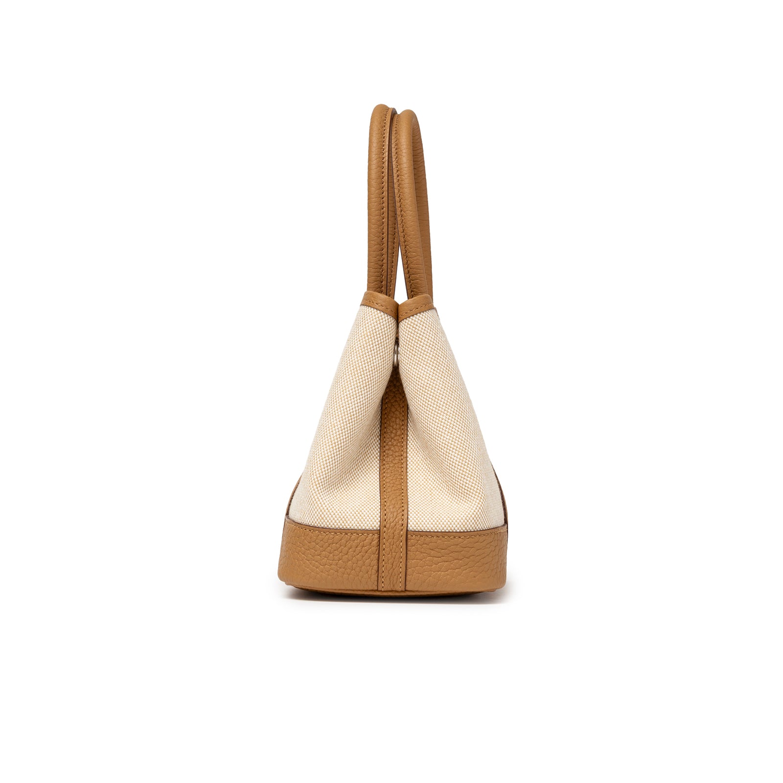 Side profile showing tan leather base and handles on Hermès Mini Garden Party Neo 23 Ecru-Paille Toile H Canvas and Sesame Negonda Palladium Hardware