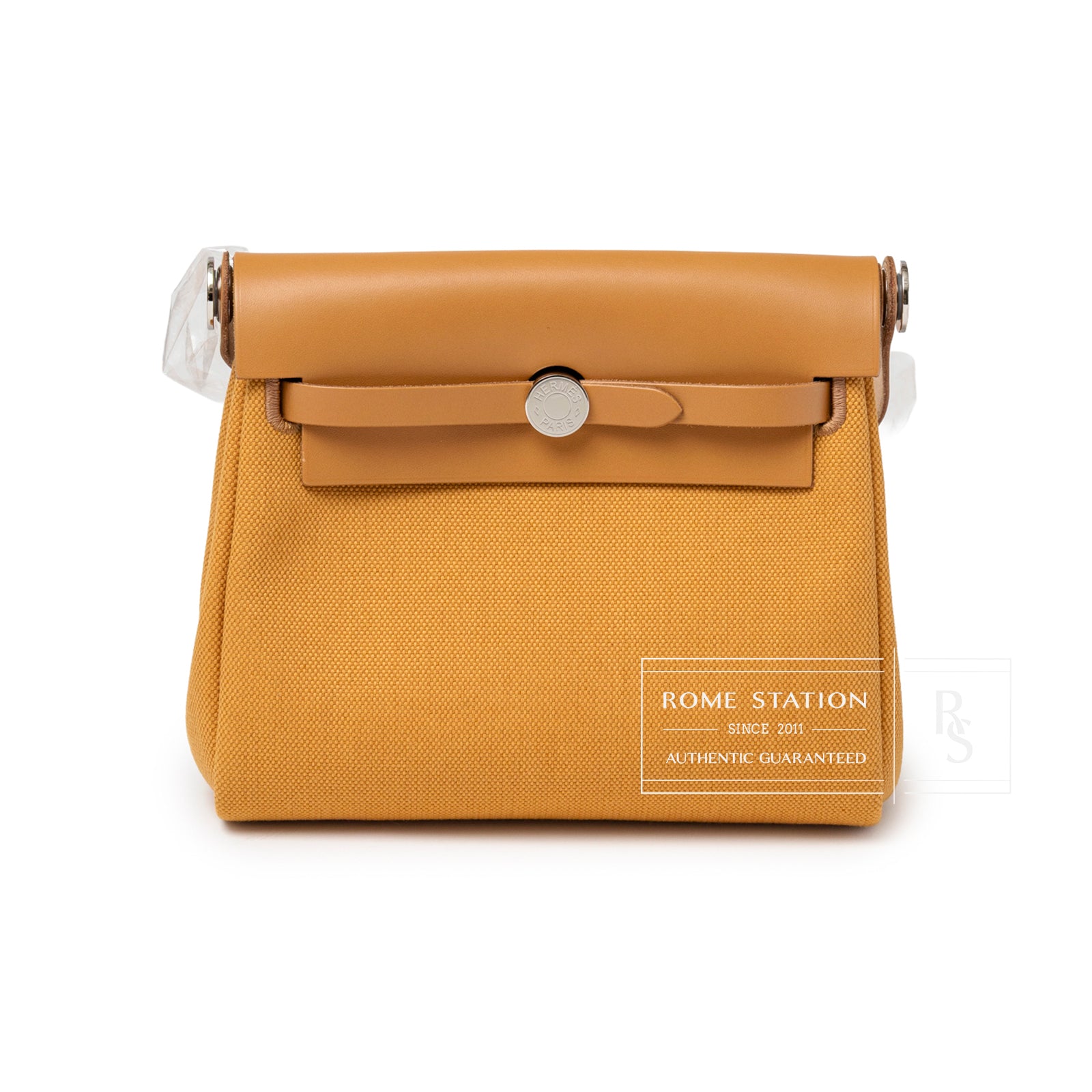 Front view of Hermès Mini Herbag Zip 20 Naturel Sable Toile and Vache Hunter Palladium Hardware showing clasp and structured silhouette
