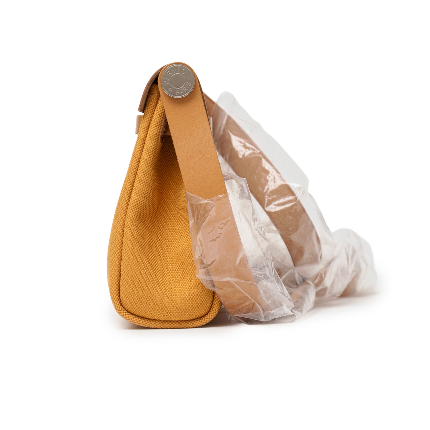 Side view of Hermès Mini Herbag Zip 20 Naturel Sable Toile and Vache Hunter Palladium Hardware showing canvas texture and wrapped handle detail