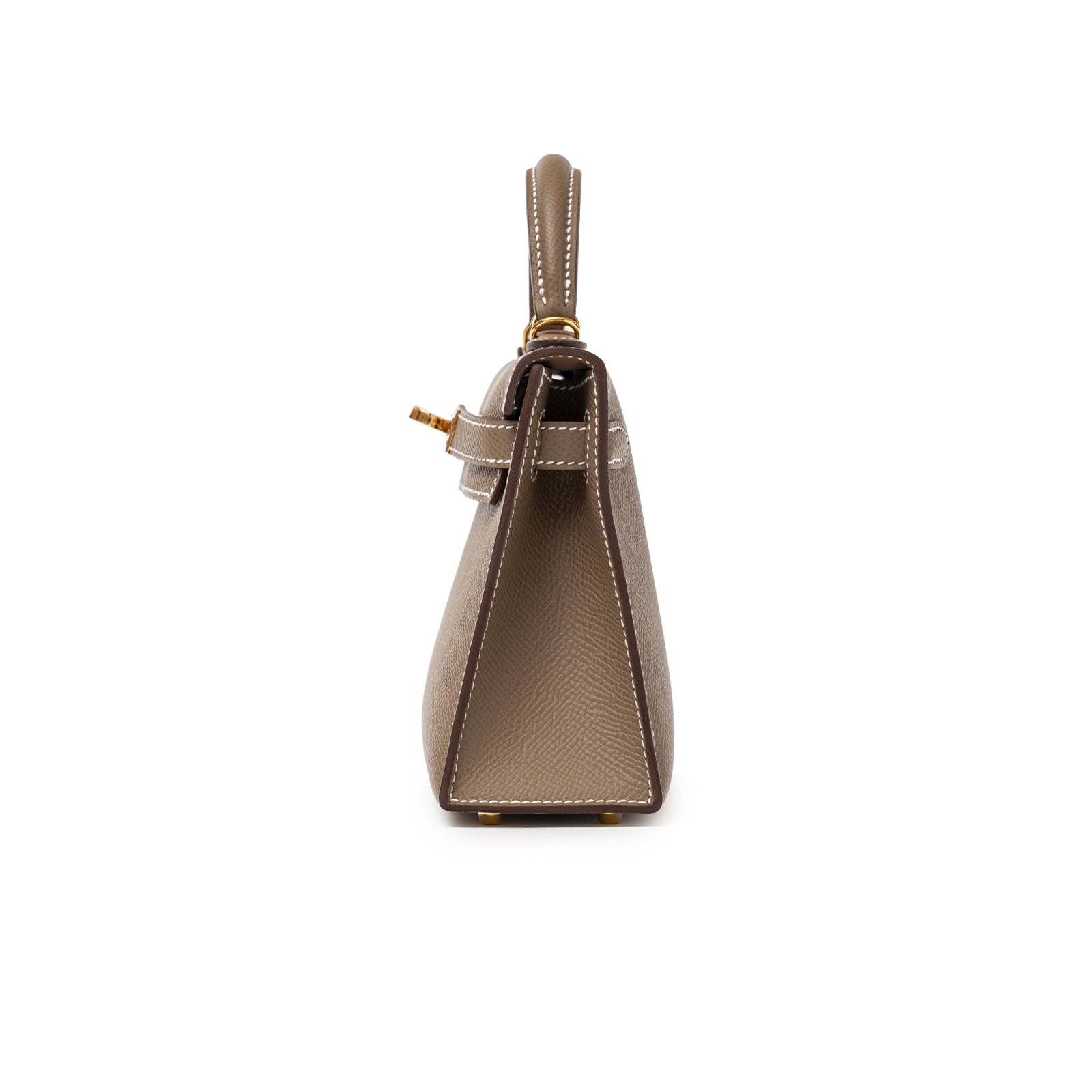 Side view of Hermès Mini Kelly II Sellier Etoupe Epsom Gold Hardware with structured profile and white stitching