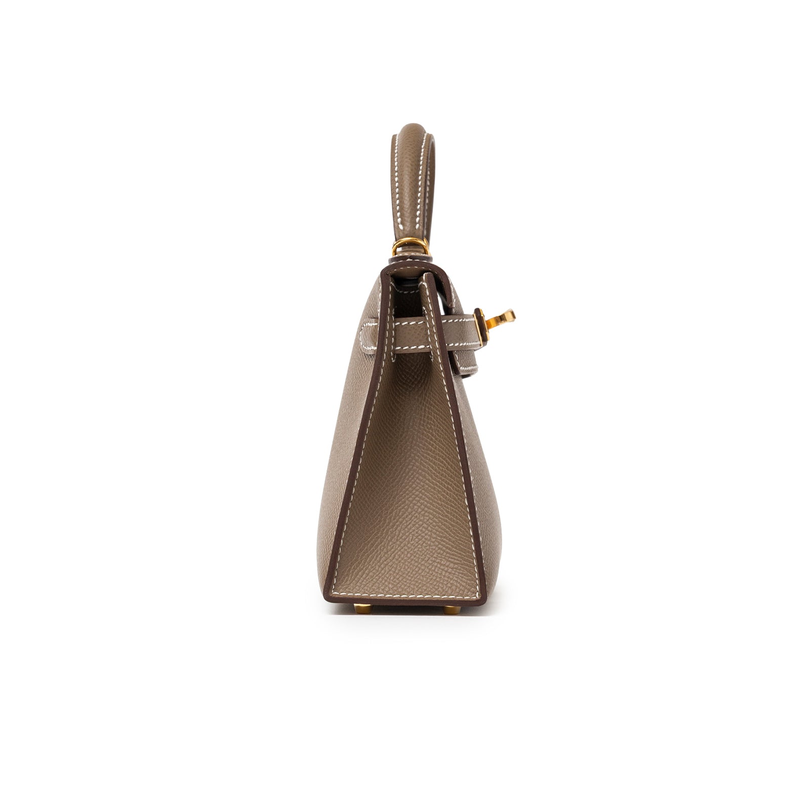 Side profile of Hermès Mini Kelly II Sellier Etoupe Epsom Gold Hardware showing structured shape and top handle detail