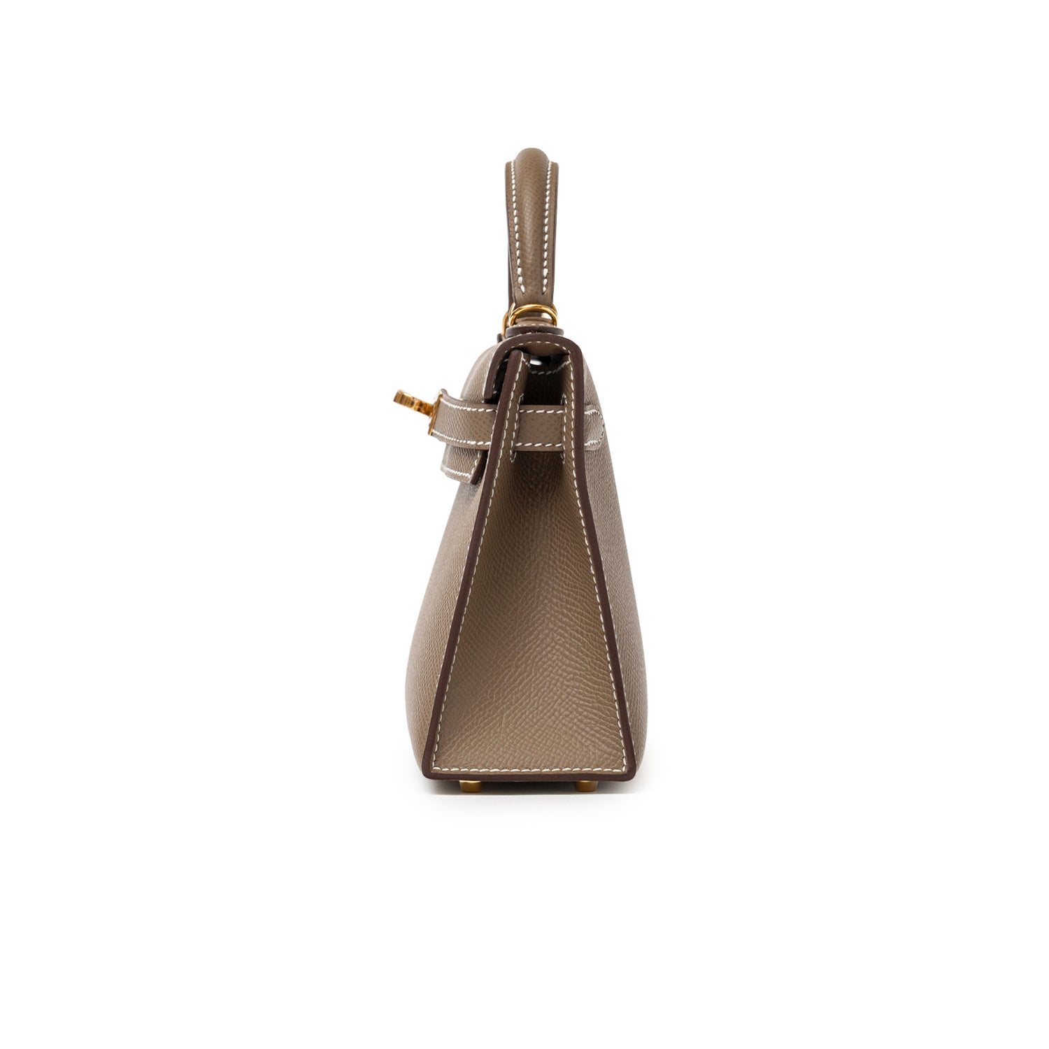 Side view of Hermès Mini Kelly II Sellier Etoupe Epsom Gold Hardware with structured profile and white stitching