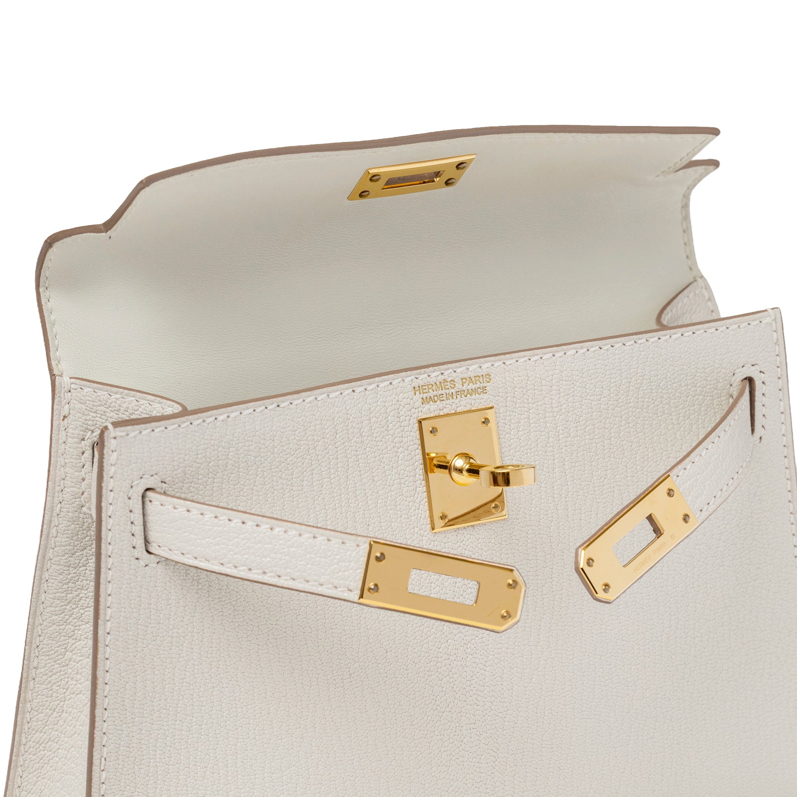 Close-up of open flap on Hermès Mini Kelly II Sellier Mushroom Chevre Mysore Gold Hardware showing interior and gold turn-lock detail