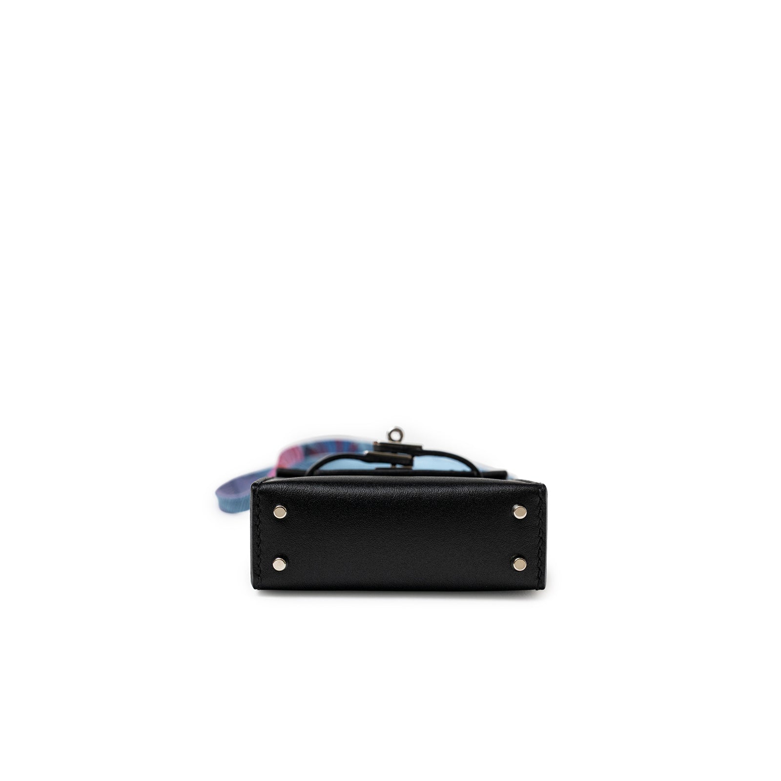 Bottom view of Hermès Mini Kelly Twilly Bag Charm Black Tadelakt Palladium Hardware with metal studs visible