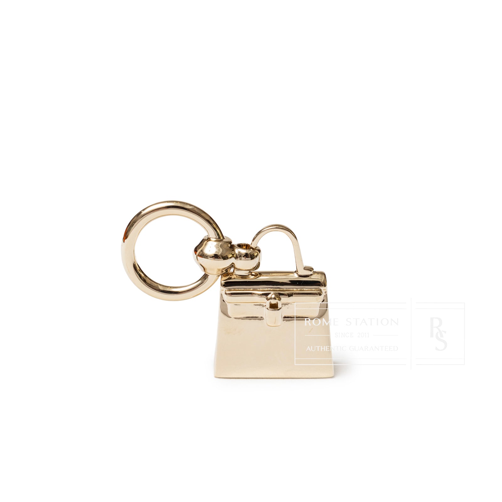 Front angle close-up of Hermès Mini Kelly Twilly Ring Palladium Plated in shiny gold-tone metal with keyring loop.