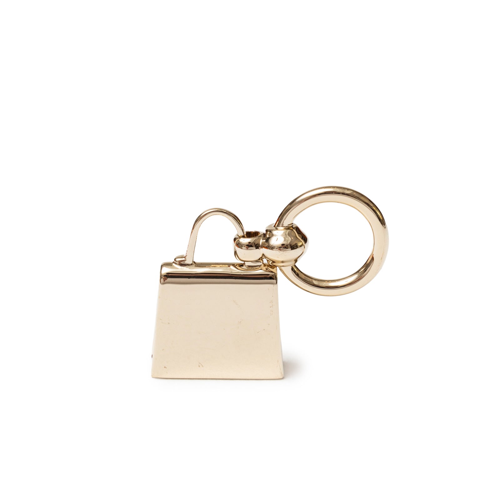 Back view of Hermès Mini Kelly Twilly Ring Palladium Plated shaped like a small polished handbag charm.
