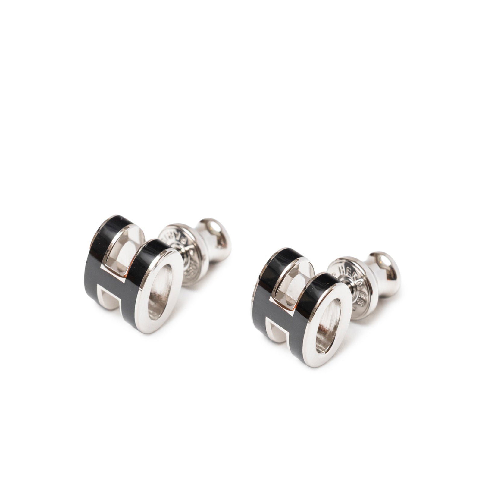Close-up front view of Hermès Mini Pop H Earrings Black Palladium Plated showing black enamel and polished metal edges.