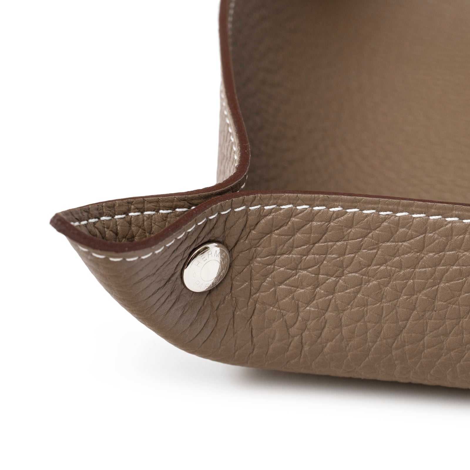 Close-up of corner showing textured Etoupe Clemence leather and silver snap button on Hermès Mises et Relances H Evelyne Change Tray Etoupe Clemence