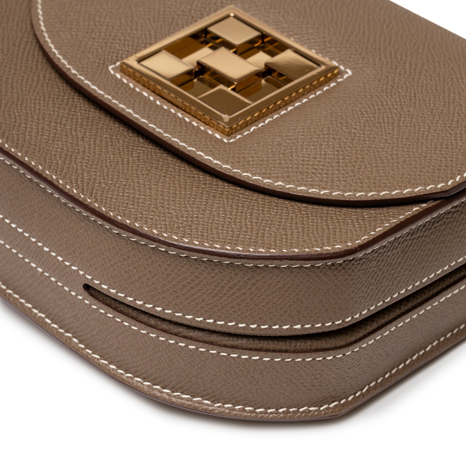 Close-up of Hermès Mosaique Au 24-17 Etoupe Epsom Permabrass Hardware showing textured leather and gold-tone clasp detail