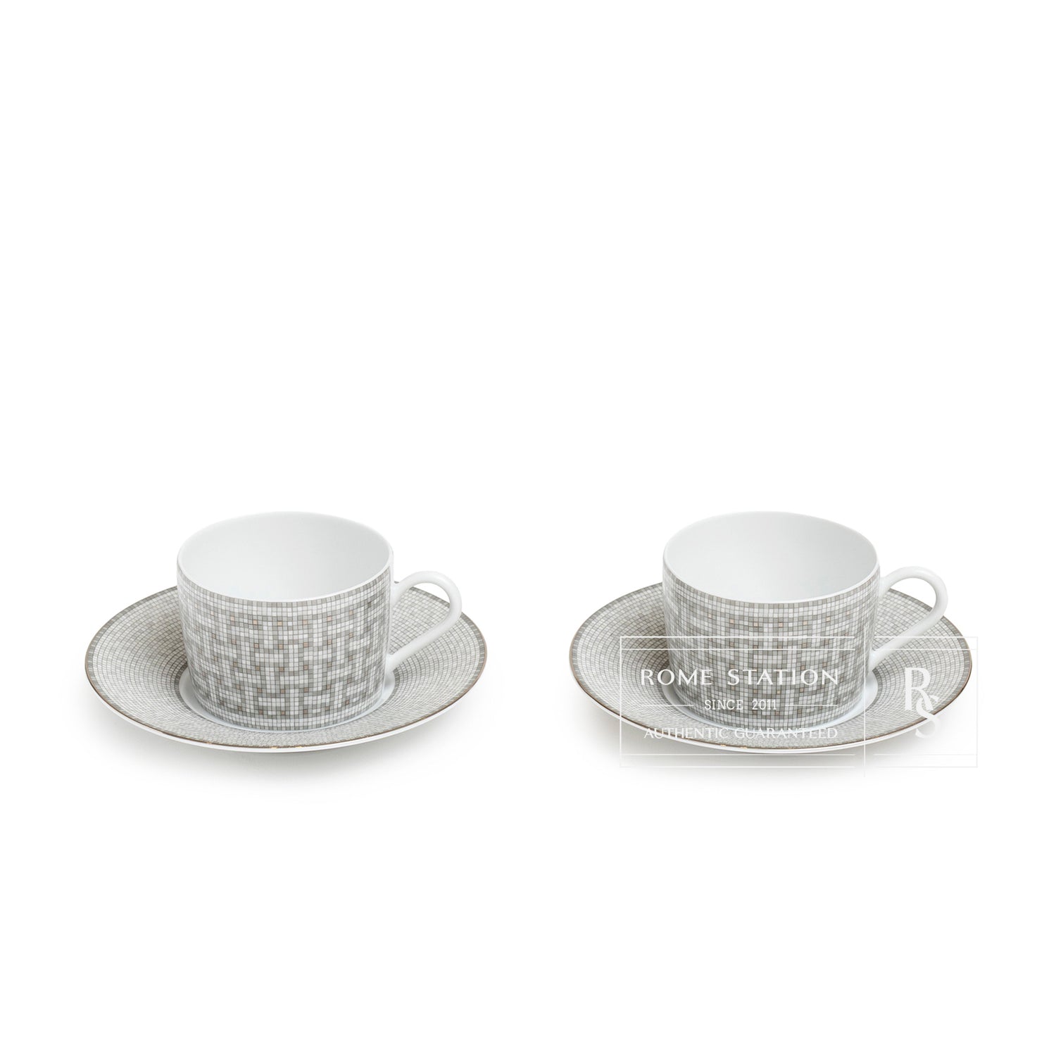 Front angled view of Hermès Mosaique au 24 Platinum Tea Cup & Saucer Set of Two featuring intricate silver patterning.