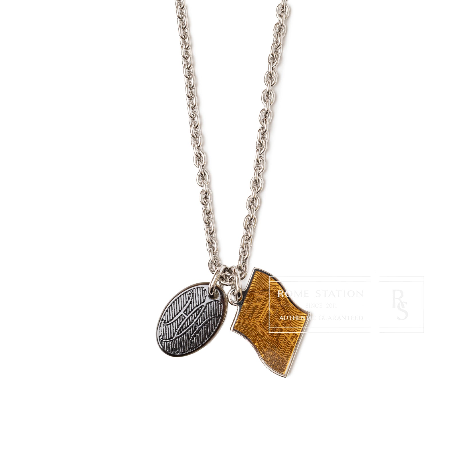 Close-up front view of Hermès Parade Necklace Orange Pulpe Transparent with silver chain and two charms.