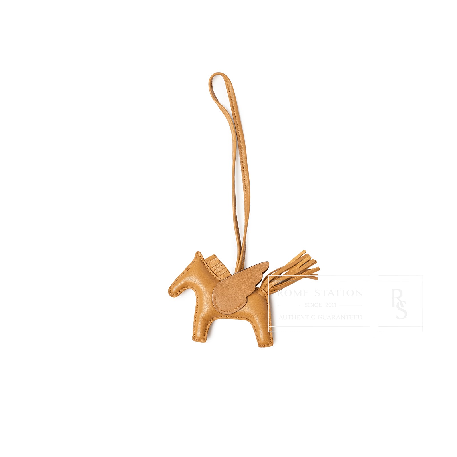 Hermès Pegase Rodeo Bag Charm PM Sesame Milo Lambskin in tan leather with wing and tassel detail, front view.