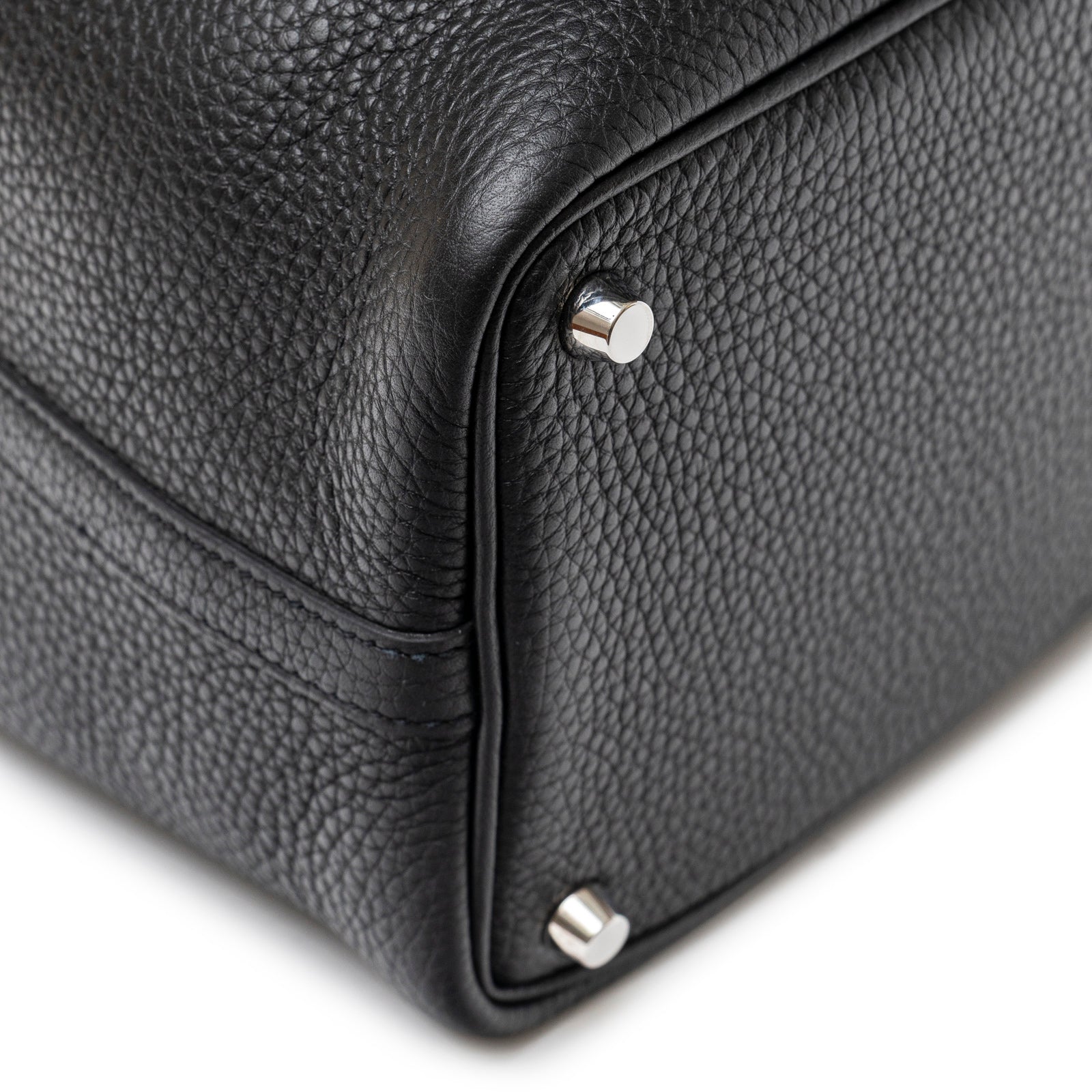 Close-up of bottom corner and palladium feet on Hermès Picotin 18 Black Clemence Palladium Hardware bag