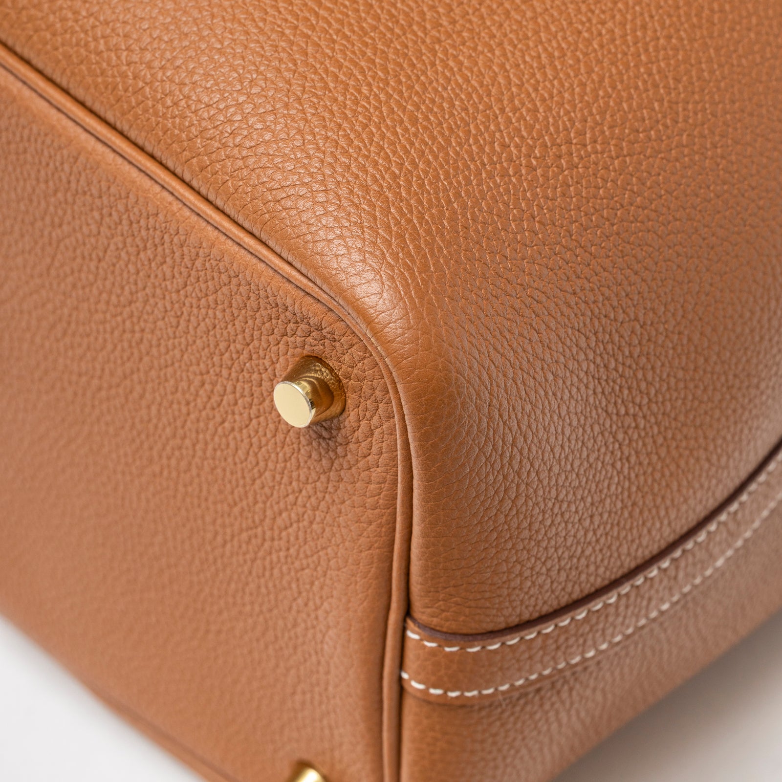Close-up of Hermès Picotin 18 Gold Clemence Gold Hardware D bag corner showing textured leather and gold stud detail