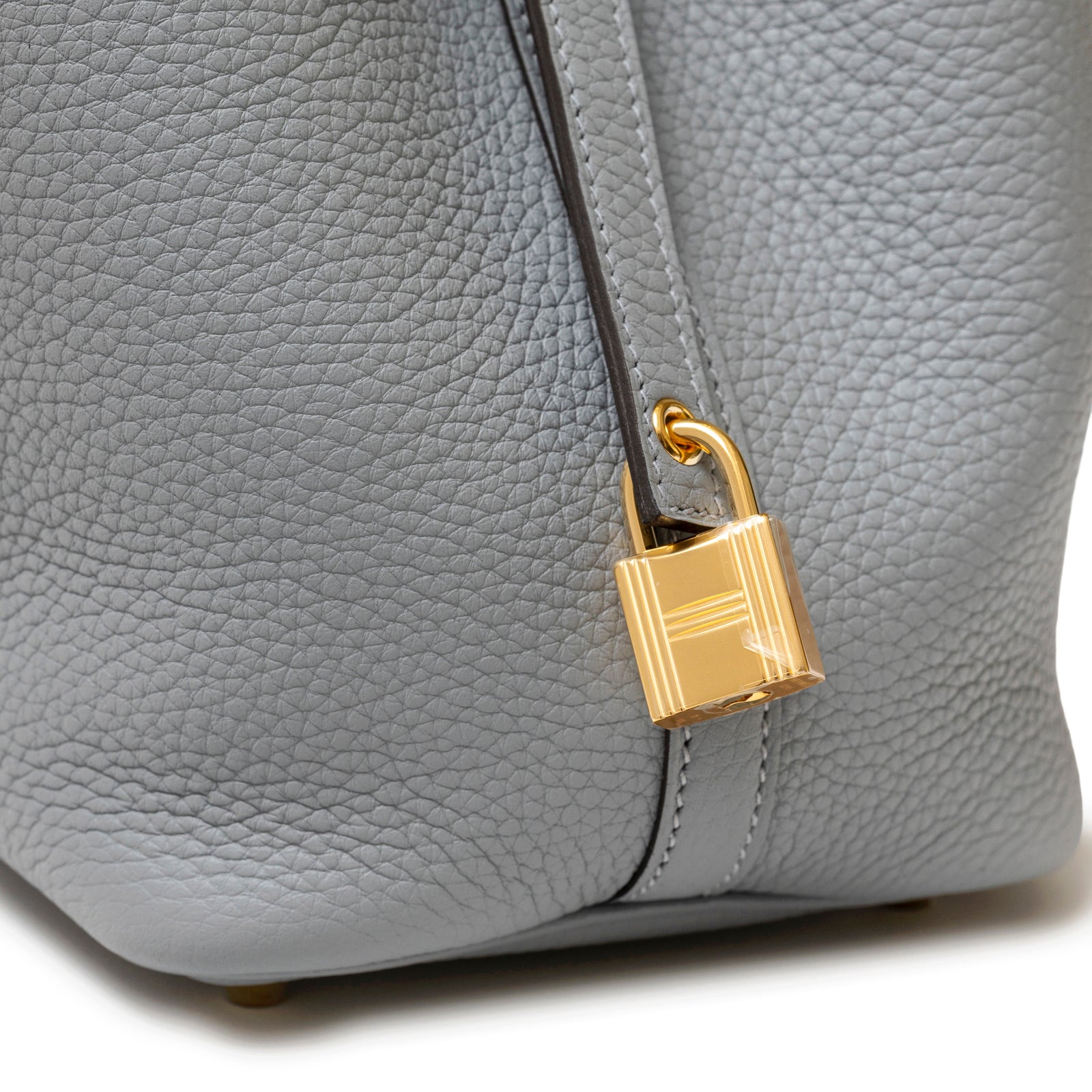 Detail close-up of Hermès Picotin 18 Gris Pantin Clemence Gold Hardware showing gold lock