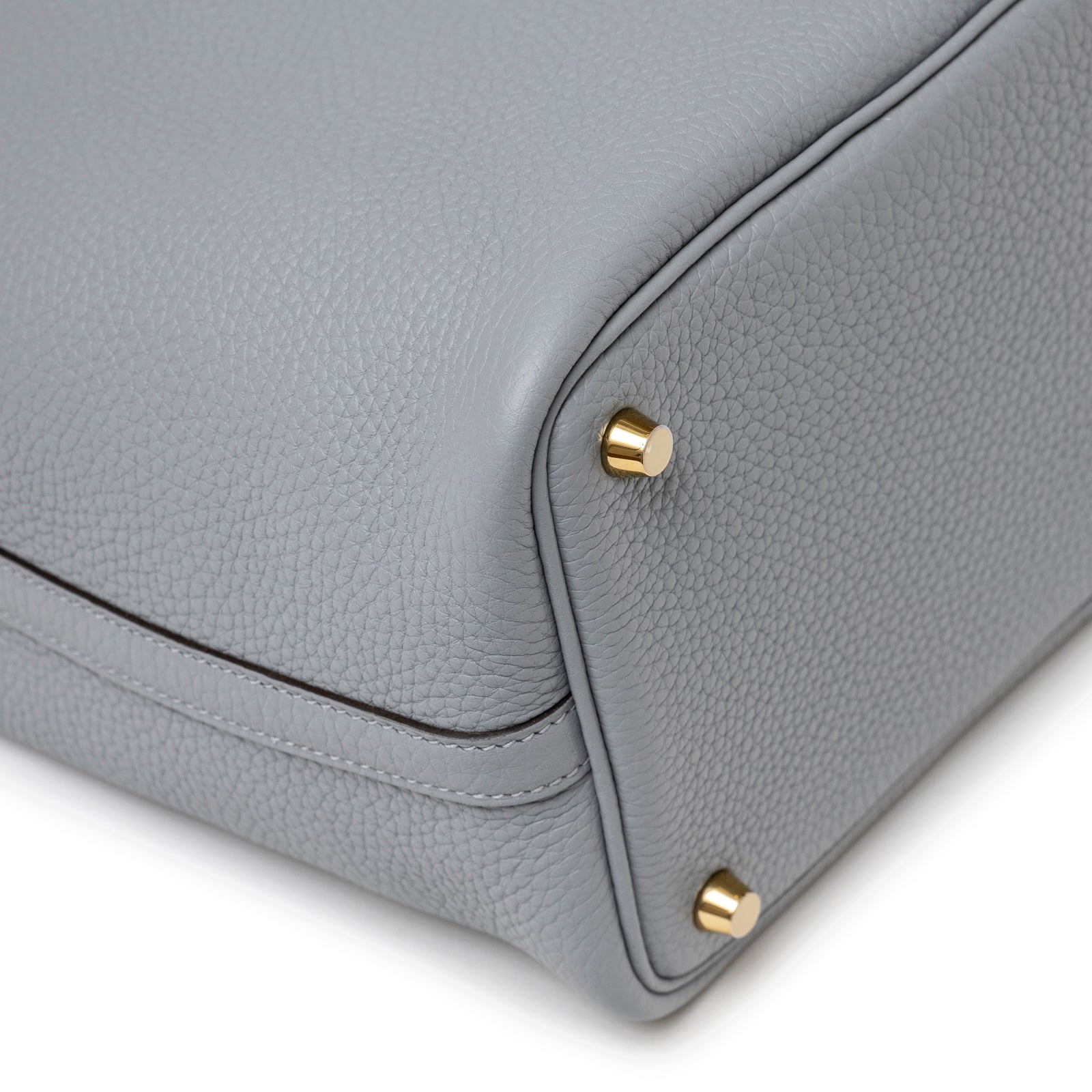 Close-up of base corner on Hermès Picotin 18 Gris Pantin Clemence Gold Hardware showing pebbled leather and gold feet details